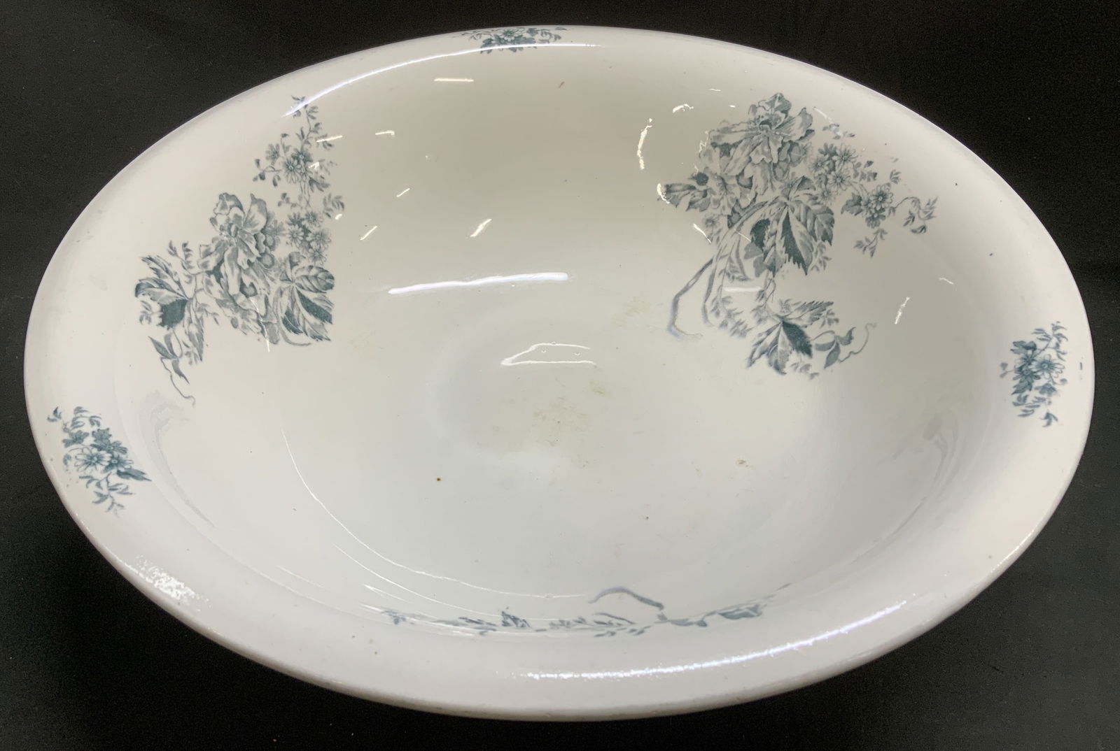 Antique Floral Motif Ceramic Wash Basin: Antique wash basin features various floral motifs on rim & interior. Ceramic material. No visible signature or markings. Surface wear consistent to age, use & exposure. Measurements: length