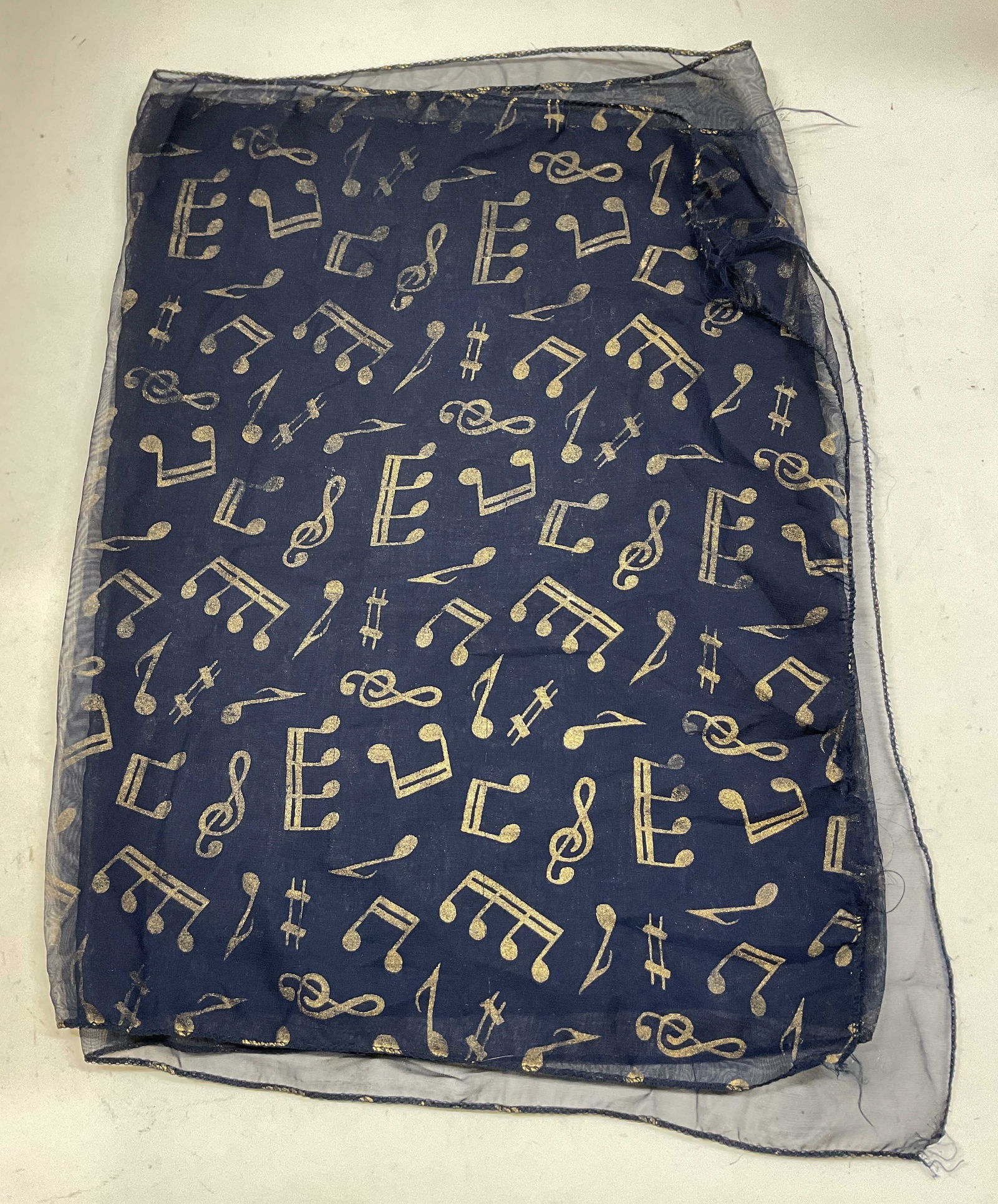 Vtg Navy Blue Sheer Music Note Silk Scarf: Vintage navy blue sheer music note silk scarf. Silk feel. Navy blue sheer background. Gold toned music note motifs. Measures approx 21 x 62 inches. Pull to stitching. Property of opera singers estate