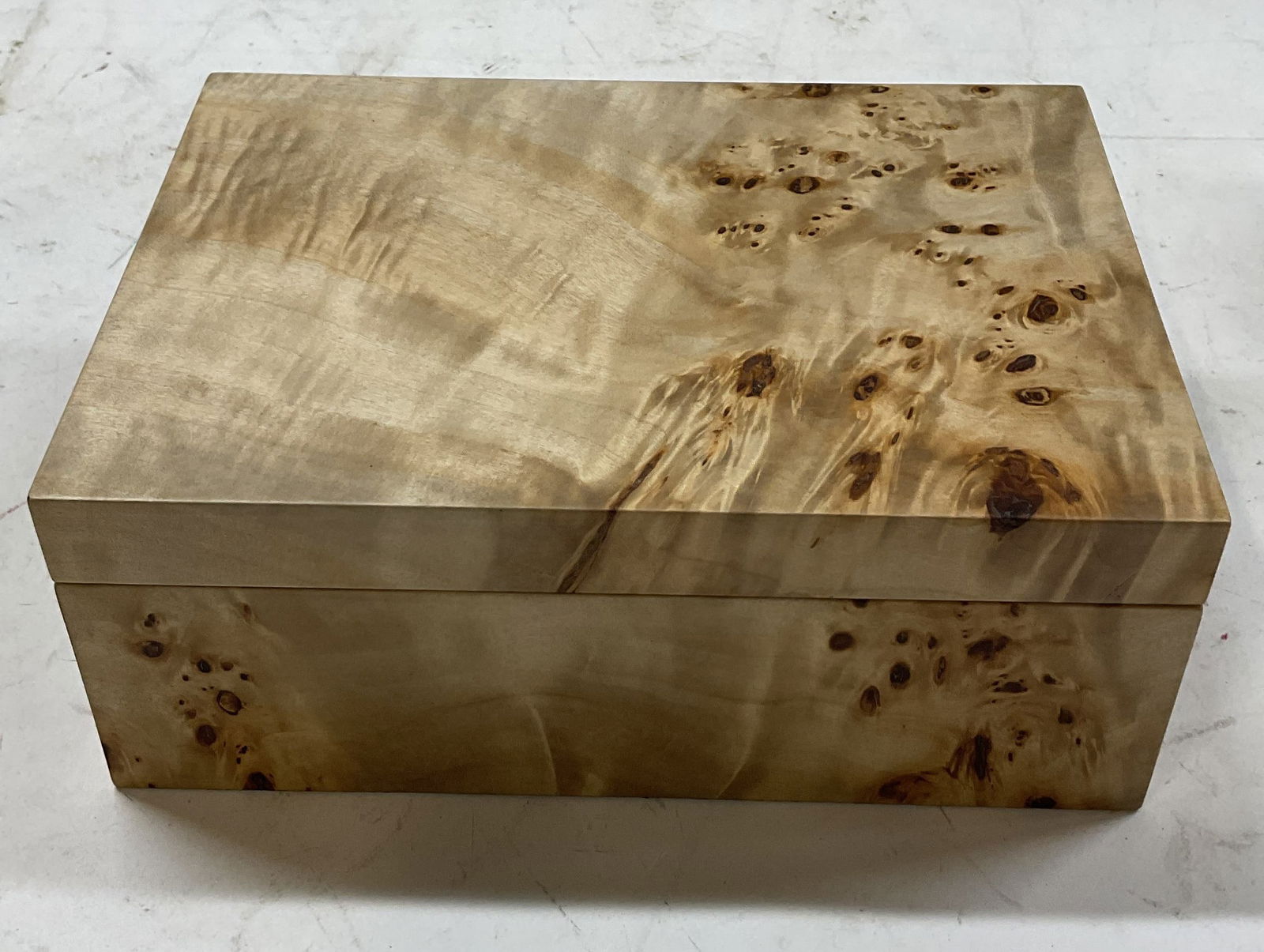 Vintage Faux Wood Hinged Box: Vintage faux wood hinged box. Rectangular box. Wood like appearance. Lined with black suede. Measures approx 10 x 7 x 4 inches. Some surface wear consistent with exposure. Box, faux wood box, hinged b