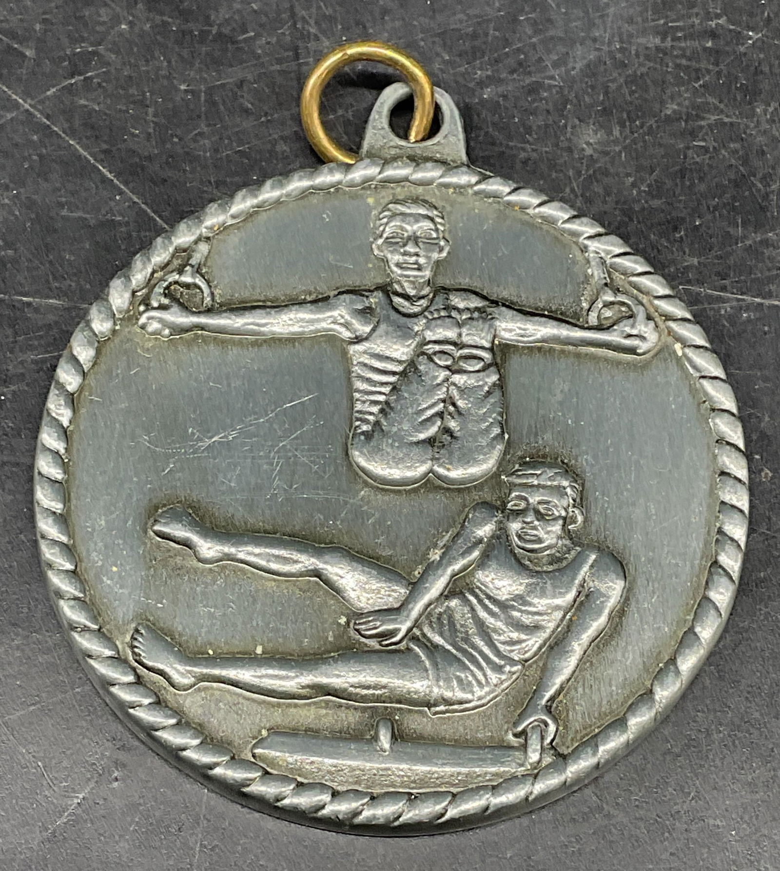 Silver Tone Gymnastics Medal Pendant: Silver tone gymnastics motif medal pendant. Measures approx. 1 7/8 inches wide. Some scratching. Jewelry, estate jewelry, costume jewelry, cocktail jewelry, fashion jewelry, accessories, fashion acces