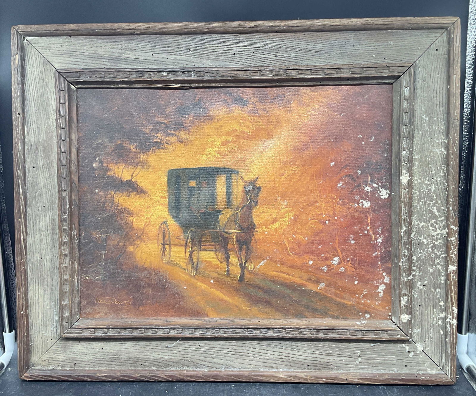 Signed Jack Down Amish Carriage Oil Painting 21in: Framed oil on canvas painting. Signed lower left, Jack Downs. Inscribed on the verso, reads Kidron, Ohio, Holmes County Amish. Man with horses and carriage. Wood frame. Not examined out of frame.