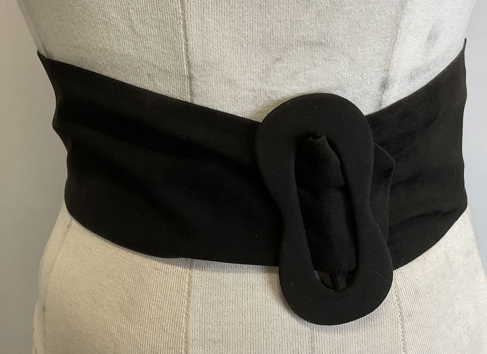 Vintage Black Suede Belt: Vintage black suede belt. Feels like suede. Wrap belt with decorative buckle. Measures approx 3.5 x 30 inches. Wear consistent with exposure. Property of opera singers estate from the renowned and opu