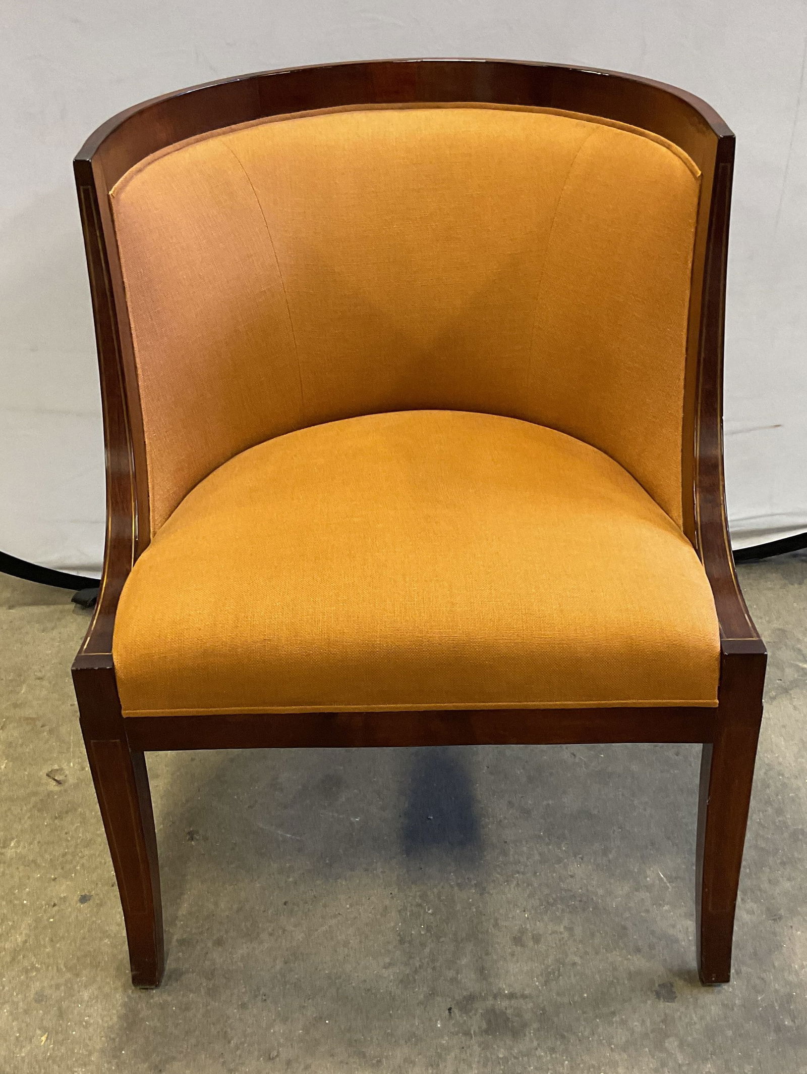 Art Deco Style Orange Upholstered Accent Chair: Art deco style upholstered orange accent chair with wood frame and curved backrest. Inlaid metal detail on arms. Measures approx. 26 x 27 x 32 inches. wear including scratching. Accent chair, side