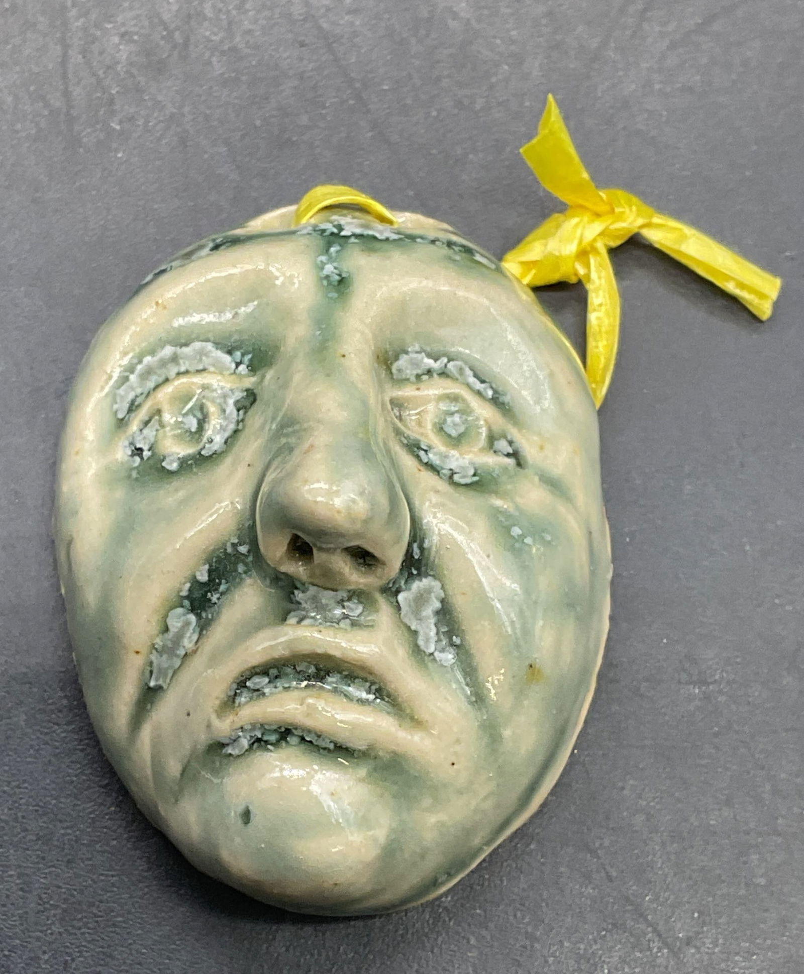 Handmade Ceramic Head of a Man Pendant: Handmade green glazed ceramic head of man pendant. Measures approx. 1.25 x 1 inches. Some scratching. Jewelry, estate jewelry, costume jewelry, cocktail jewelry, fashion jewelry, accessories, fashion