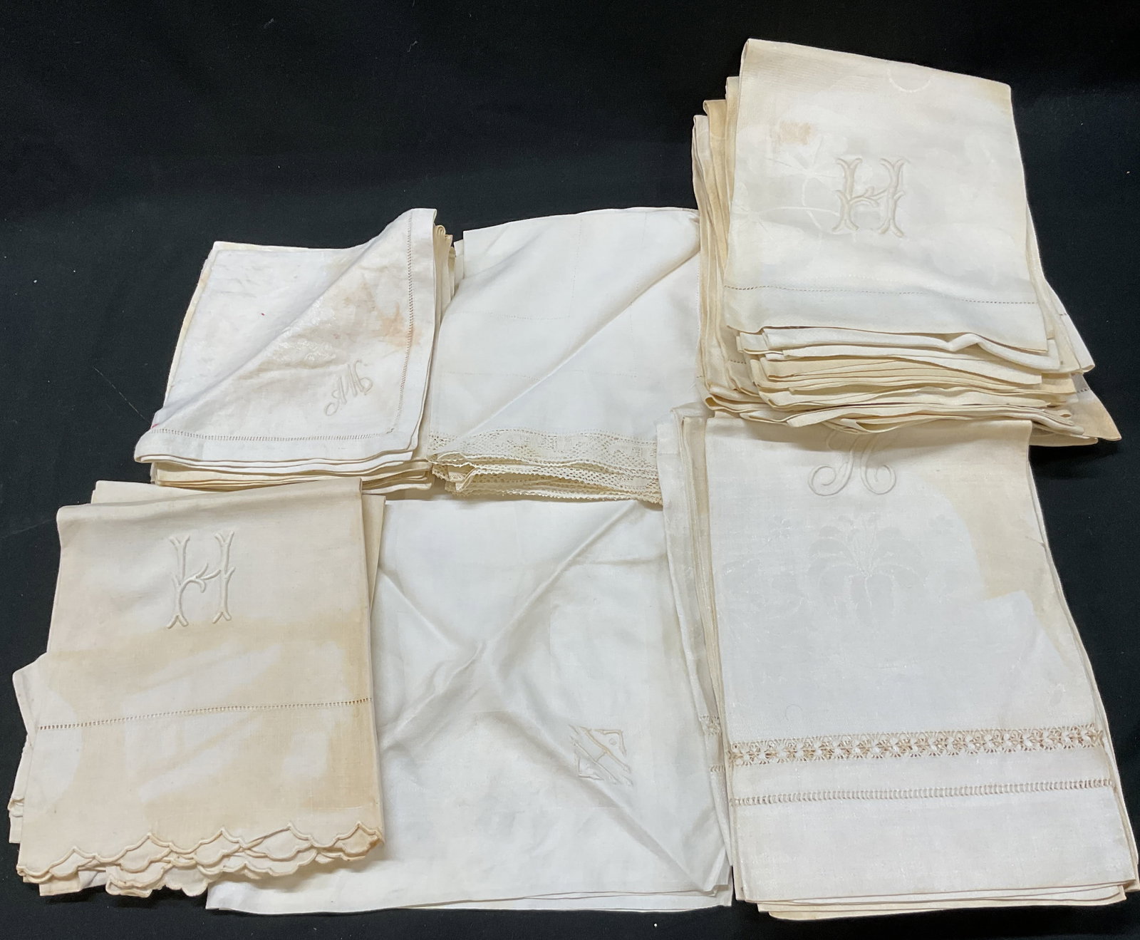 Grp Lot 31 Vintage Embroidered Monogram Linens: Group lot of 31 vintage white embroidered monogram linens. Includes 15 napkins and 16 tea towels. Linen material. Embroidered floral and scroll motifs. Scalloped trim. Embroidered monograms.