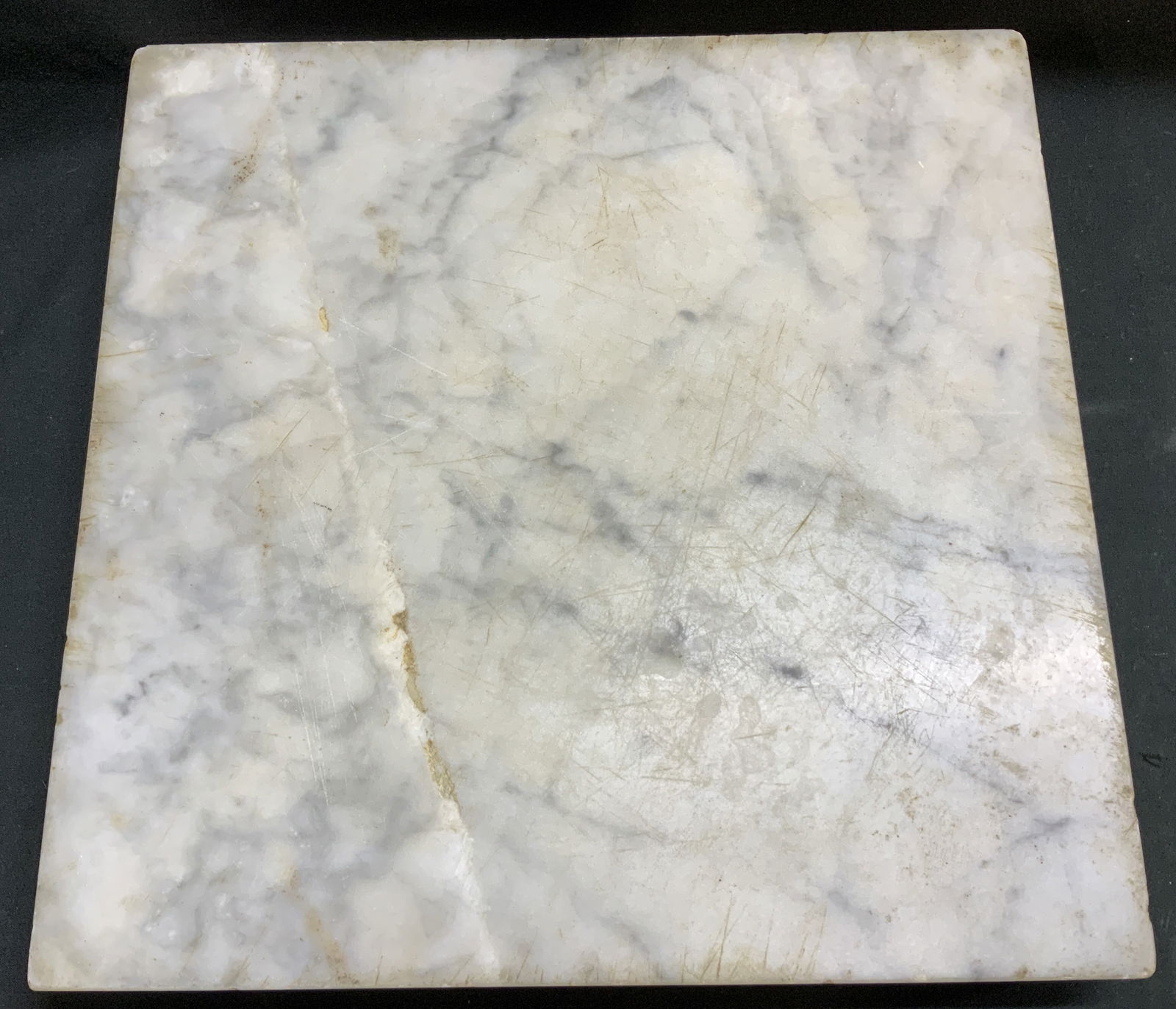 IMI Marble Cutting Board W Brass Feet ITALY: White marble cutting board features 4 brass feet on underside. Square shape. Signed & marked on underside. Reads, IMI MADE IN ITALY. Surface wear consistent to age, use & exposure. Measurements: lengt