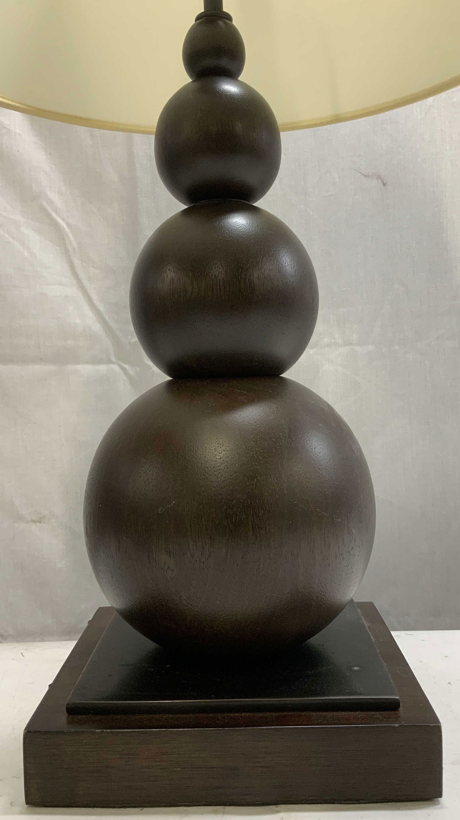 Visual Comfort & Co. Wooden Table Lamp: Visual Comfort & Co. wooden table lamp features 4 stacked spheres. Square base & dark toned. White drum shade. Table lamp has not been tested for function, lot is sold as is. Signed & marked. Reads, V