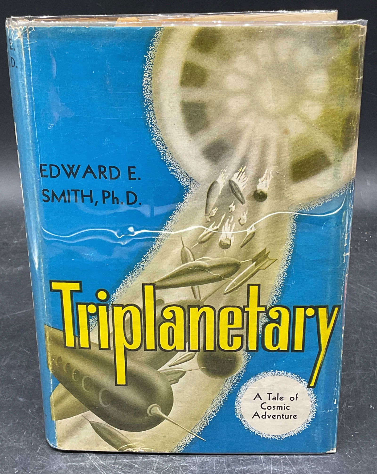 1950 Edward E Smith Triplanetary, Illustrated: Hardcover copy of Triplanetary by Edward E Smith. E. E. Doc Smith. Appears to be a second edition. Fantasy Press, 1950. Illustrated. Measures approx. 7.75 x 5.5 inches. Wear to cover, pages, and bindi