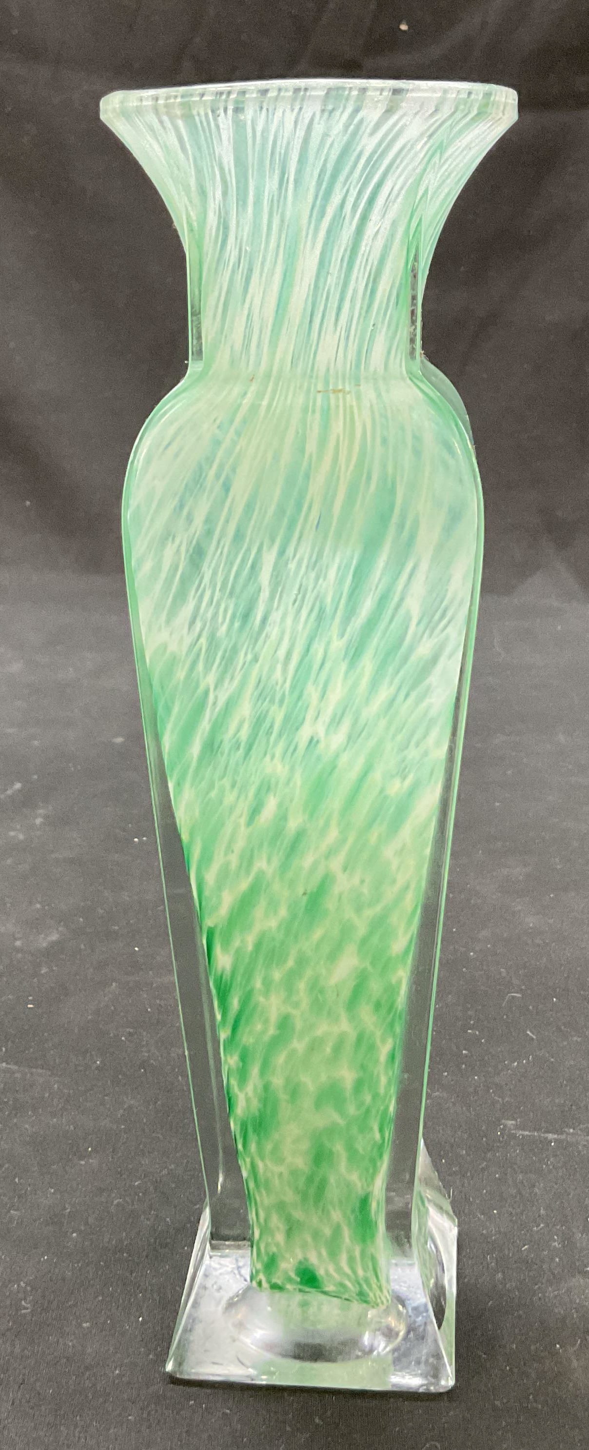 Vintage Art Glass Swirled Bud Vase: Vintage art glass swirled bud vase. Green and white swirled pattern. Square pedestal base. Encased in clear glass. Flared rim. Faceted body. Measures ht approx 8 inches diam approx 2.5 inches. Surface