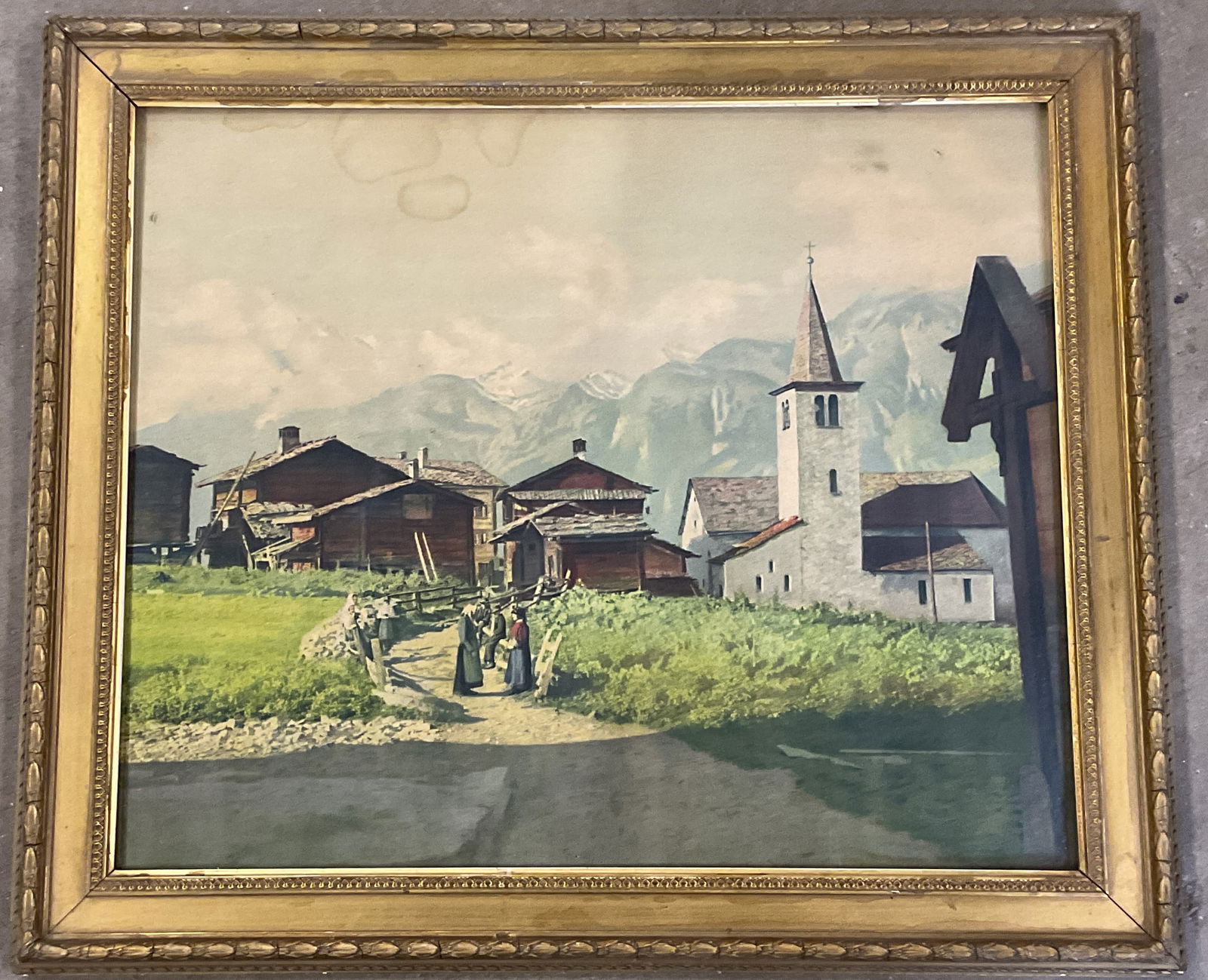 Framed Pastoral Village Scene Lithograph 23in: Framed lithograph, pastoral scene with figures and village. Decorative gilt wood frame. Not examined out of frame. Frame measures approx. 19.75 x 23 inches. Wear to frame in scratching, chips, hairlin