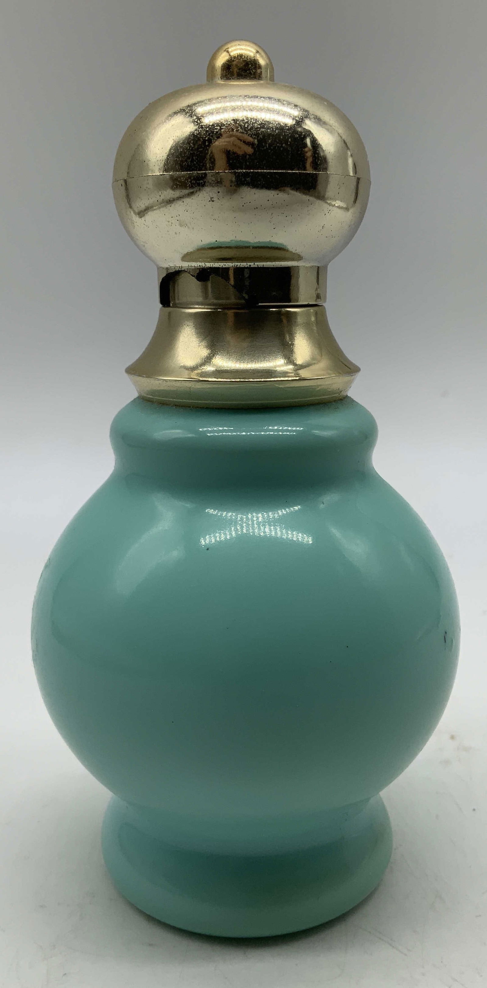 Avon Bird of Paradise Cologne Mist Bottle NY USA: Avon Bird of Paradise cologne mist bottle features a gold toned top & blue body. Round body. Signed & marked on underside. Reads, AVON BIRD OF PARADISE COLOGNE MIST. AVON PRODUCTS NY. Surface