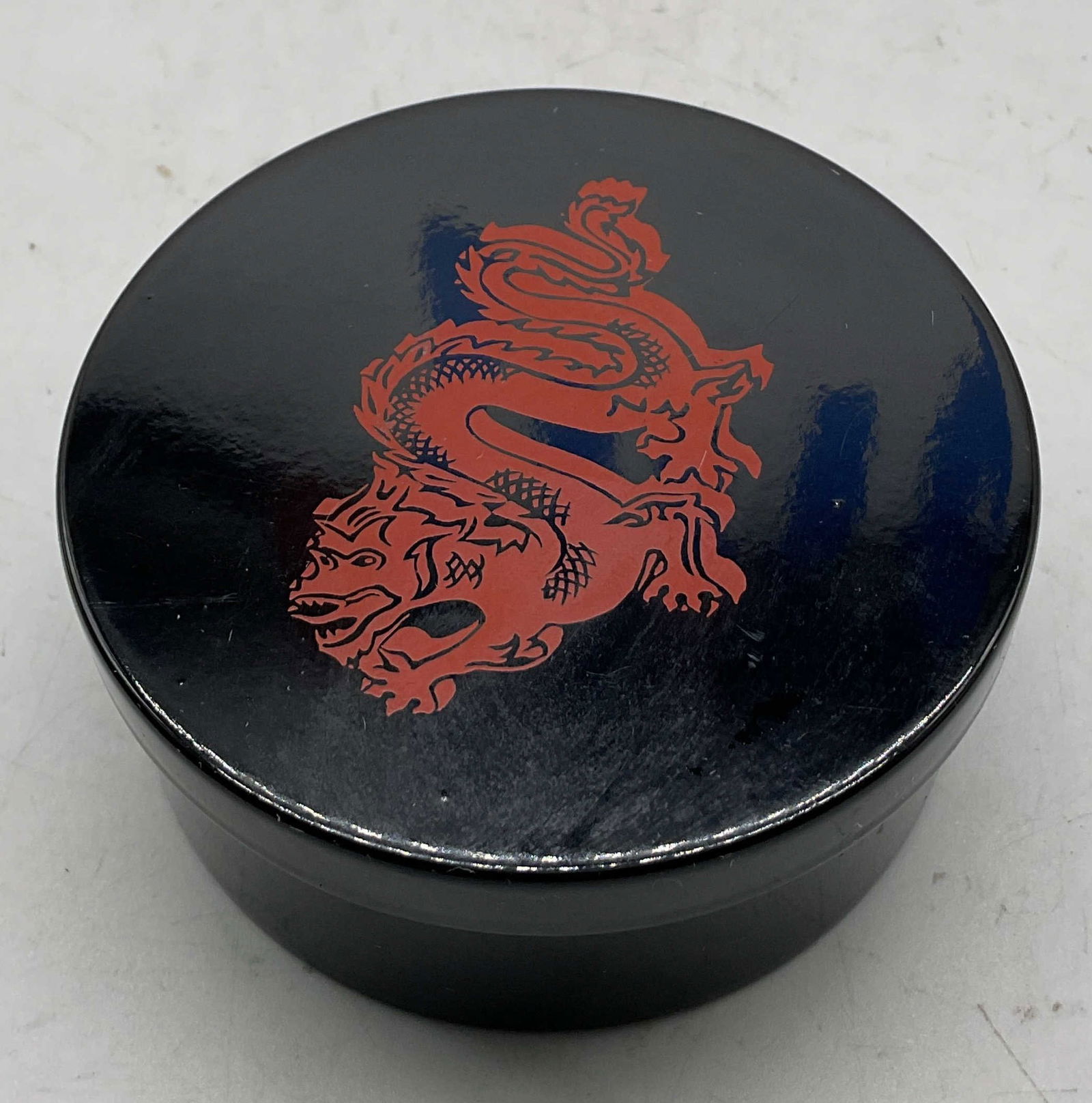 Vintage Black Lacquer Dragon Trinket Box Japan: Vintage black lacquer dragon lidded trinket box. Marked on underside, made in Japan. Circular box. Red dragon motif on lid. Red velvet lining. Measures ht approx 1.5 inches diam approx 4 inches. Some