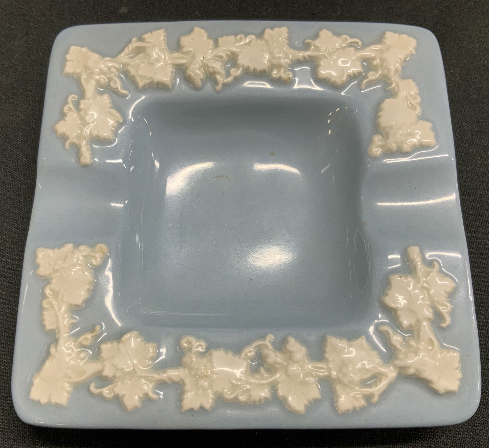 Vtg Wedgwood Etruria & Barlaston Ashtray ENG: Vintage Wedgwood ashtray from the Etruria & Barlaston line, featuring embossed white grapevines. Blue toned. Ceramic material. Signed & marked on underside. Reads, Made In England Wedgwood