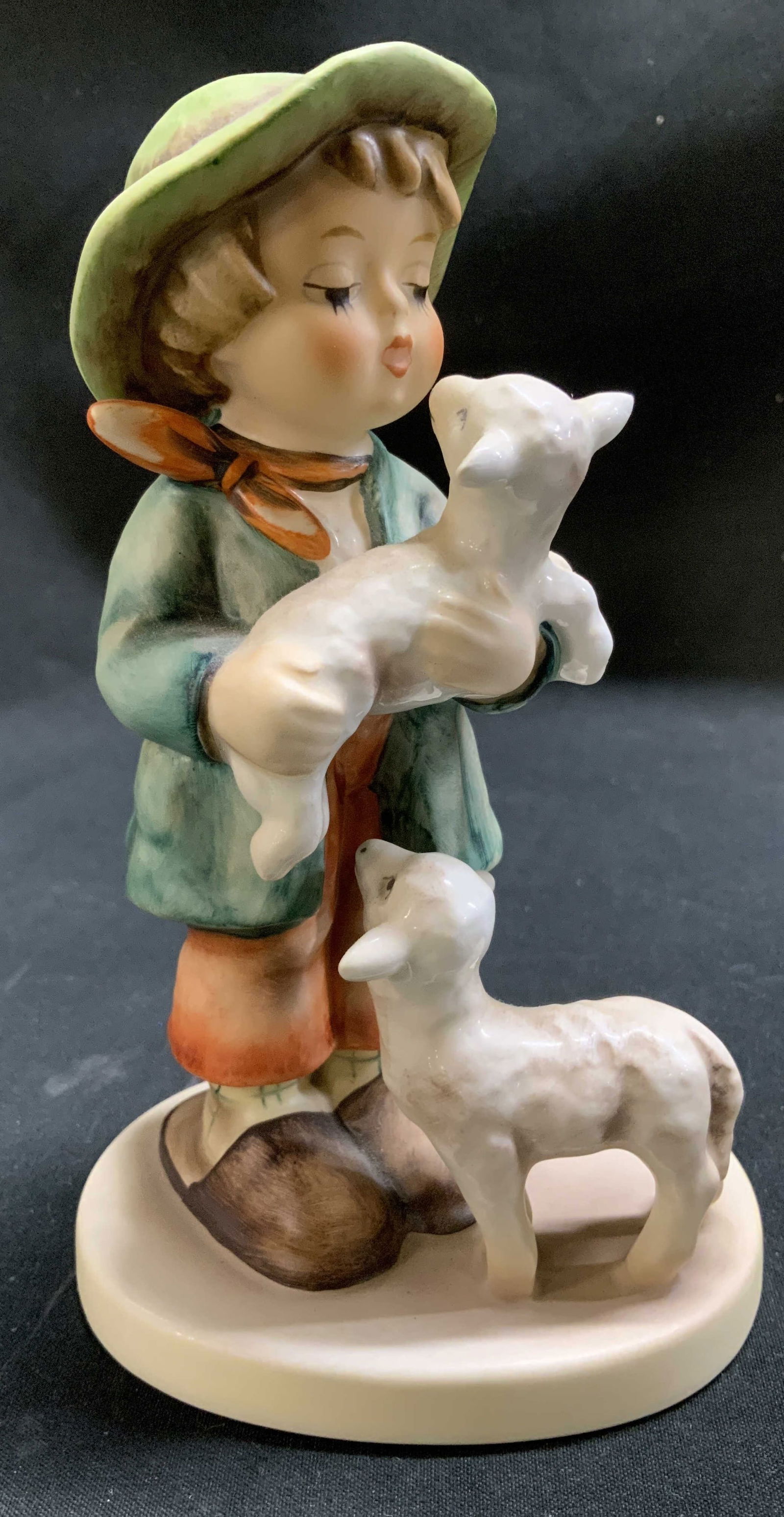 Vtg Goebel Shepherds Boy Ceramic Fig W GERMANY: Vintage Goebel ceramic figurine depicts a young boy holding a baby lamb while another lamb stands at his feet. Signed & marked on underside. Reads, GOEBEL W GERMANY. 64 5. Surface wear consistent to a