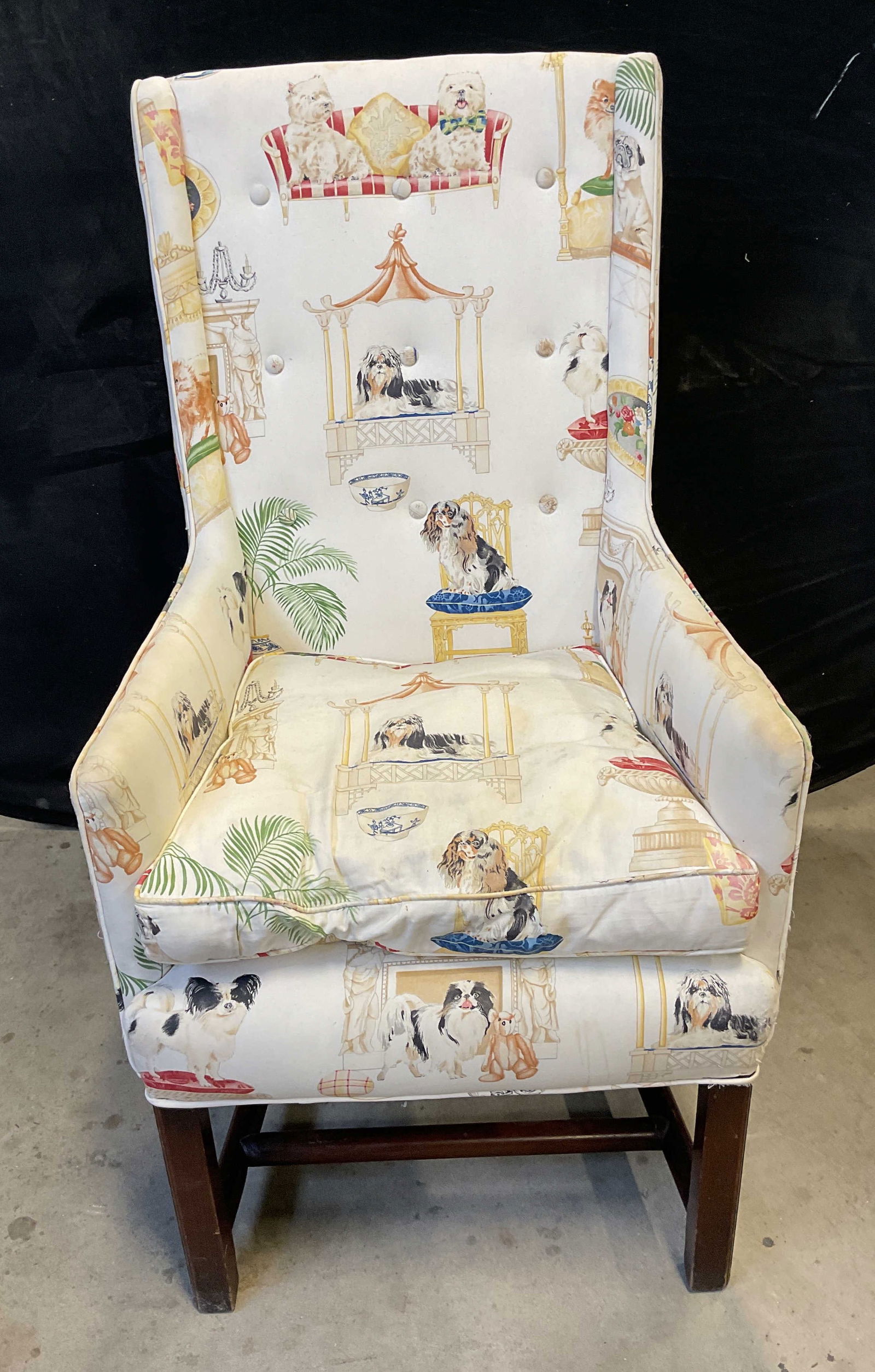 White Upholstered Dog Print Armchair: White upholstered dog print armchair with wood frame. Measures approx 21 x 23.5 x 43 inches. Wear including pulling, blemishes and scratching. Armchair, dog armchair, white armchair, upholstered armch