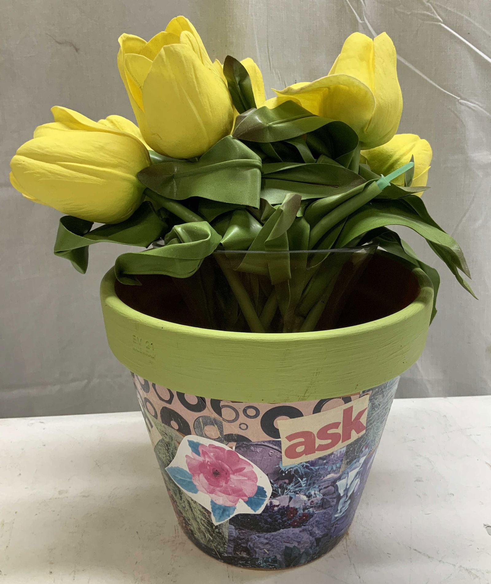Vtg EV Collage Pot W Yellow Faux Flowers ITALY: Lot includes, 1 pottery pot featuring a decoupage collage design & yellow faux flowers in clear vase. Lot is sold as is. Signed & marked. Reads, EV 21. ITALY. Surface wear consistent to age, use & exp