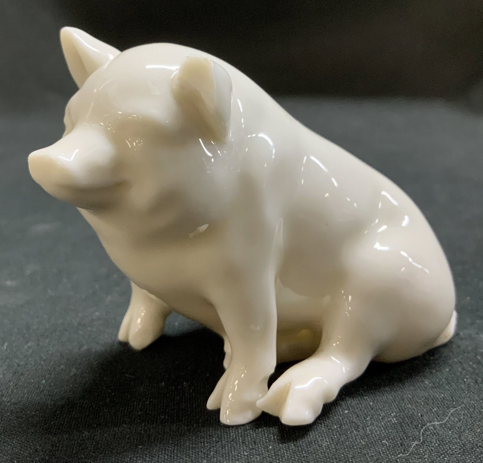 Vtg Belleek Porcelain Pig Figurine IRELAND: Vintage Belleek porcelain pig figurine. Features a glossy finish. Pig is in a seated position. Signed & marked on underside. Reads, BELLEEK CO FERMANACH IRELAND. Surface wear consistent to age, use & 