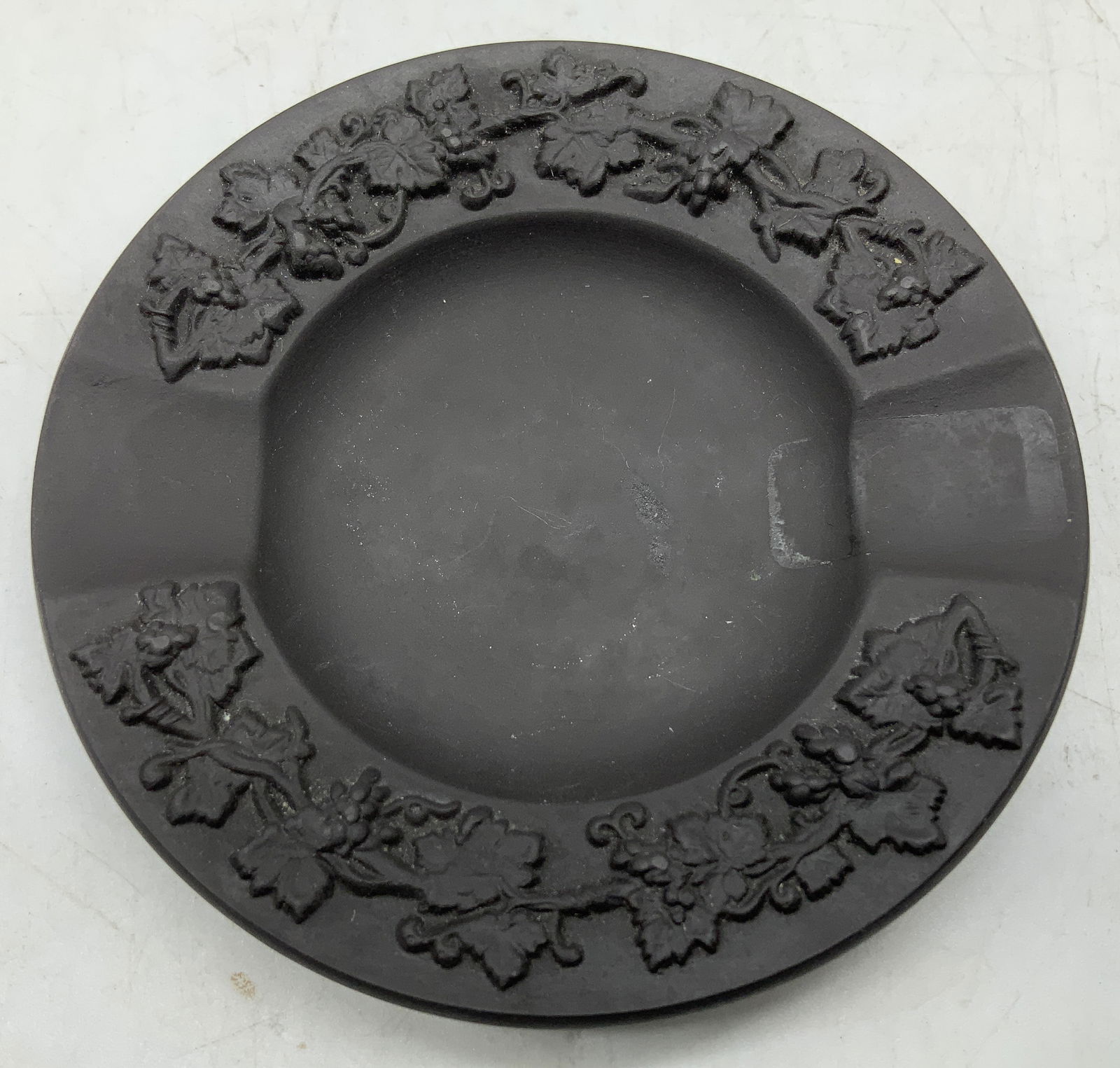Wedgwood Black Embossed Ashtray ENGLAND: Wedgwood ashtray features a matte black finish & raised embossed grapevine pattern around the rim. Signed & marked on underside. Reads, WEDGWOOD MADE IN ENGLAND 62. Surface wear consistent to age, use