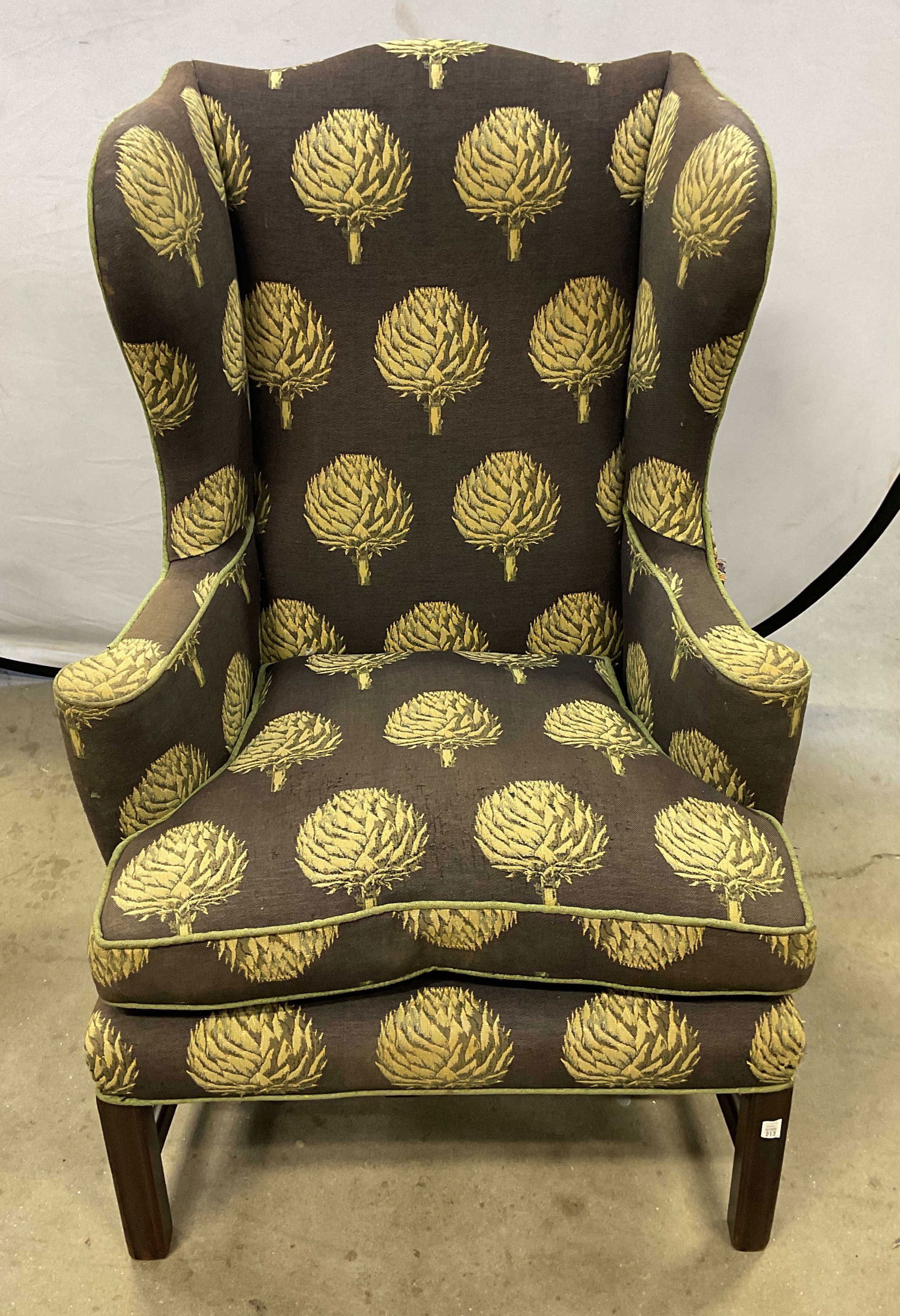 Vintage Black Artichoke Upholstered Armchair: Vintage upholstered armchair with black and green artichoke pattern. Measures approx 25 x 26 x 43.5 inches. Wear including fading, tearing to upholstery, loose pieces. Armchair, upholstered armchair,