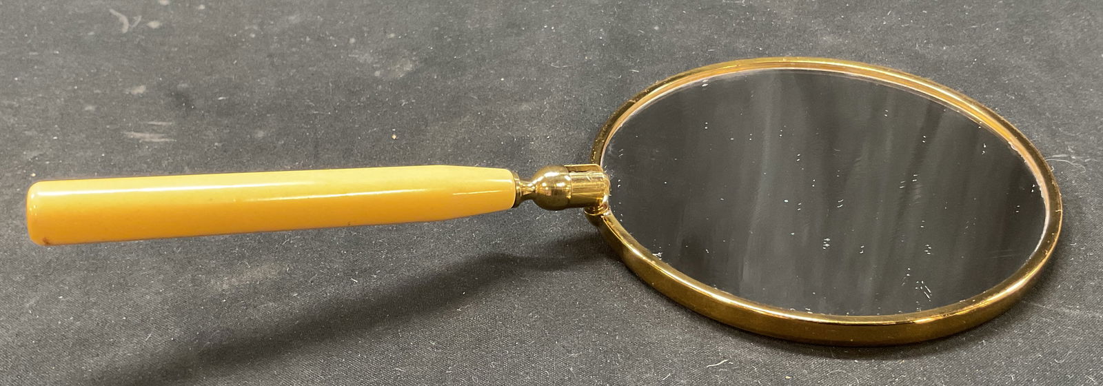 Vintage Matson Vanity Handheld Foldable Mirror: Vintage Matson vanity handheld foldable mirror. Brass toned frame and foldable bakelite handle. Circular mirror. Double sided mirror. Measures approx 4.5 x 9.5 inches. Some scratching. Mirror, foldabl