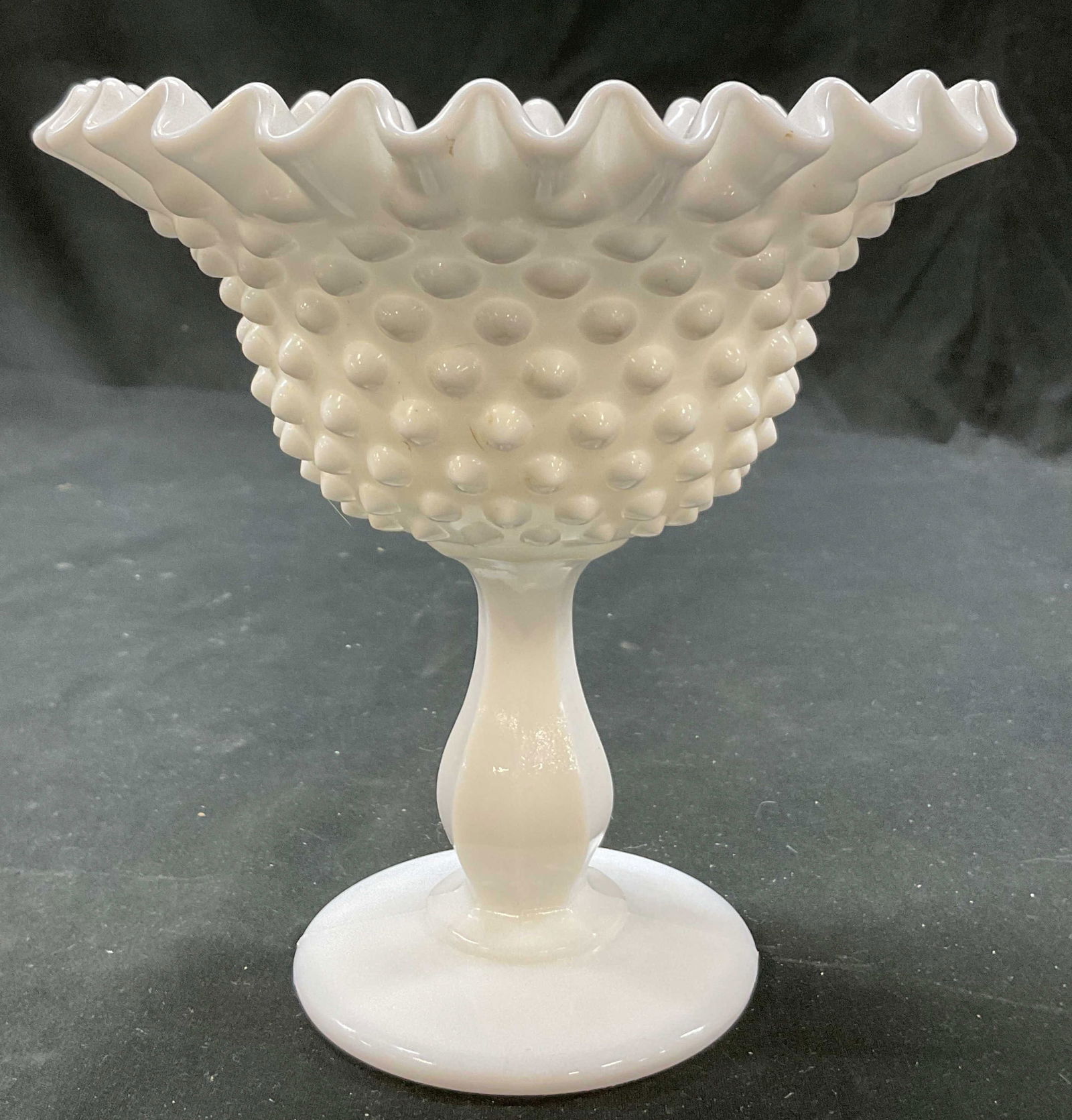 Vintage Milk Glass Hobnail Ruffle Pedestal Dish: Vintage milk glass hobnail ruffle pedestal dish. Round pedestal base with faceted stem. Hobnail textured pattern. Ruffled and scalloped edge. Measures ht approx 5.5 inches diam approx 6 inches. Some s