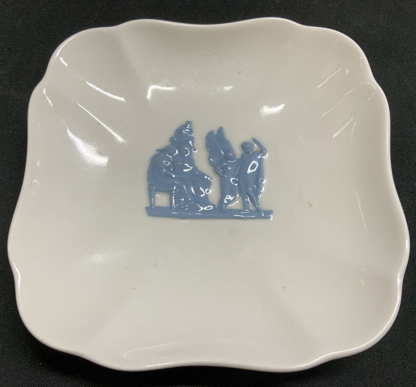 Vtg Wedgwood Etruria & Barlaston Trinket Dish: Vintage Wedgwood Etruria & Barlaston trinket dish features a classical relief scene in center. Scalloped edges. Ceramic material. Signed & marked on underside. Reads, WEDGWOOD OF ETRURIA & BARLASTON.
