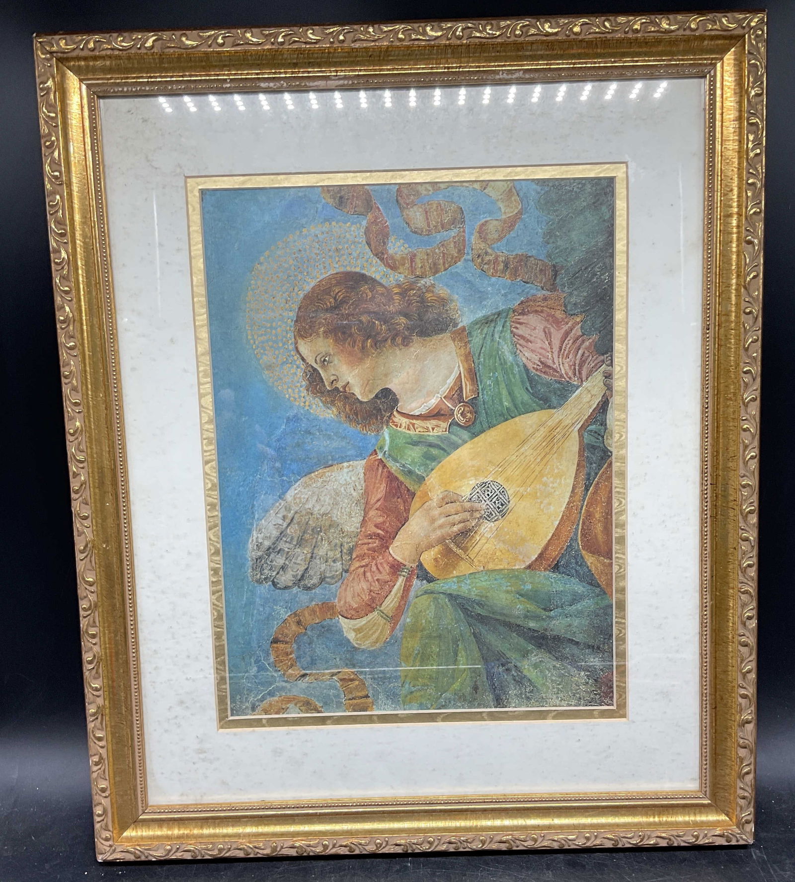 Framed After Forli Angel Musician Lithograph: Framed and matted lithograph. After Melozzo da Forli. Angel musician. Angel playing a lute. Gilt wood frame. Not examined out of frame. Frame measures approx. 18.25 x 15.25 inches. Some wear