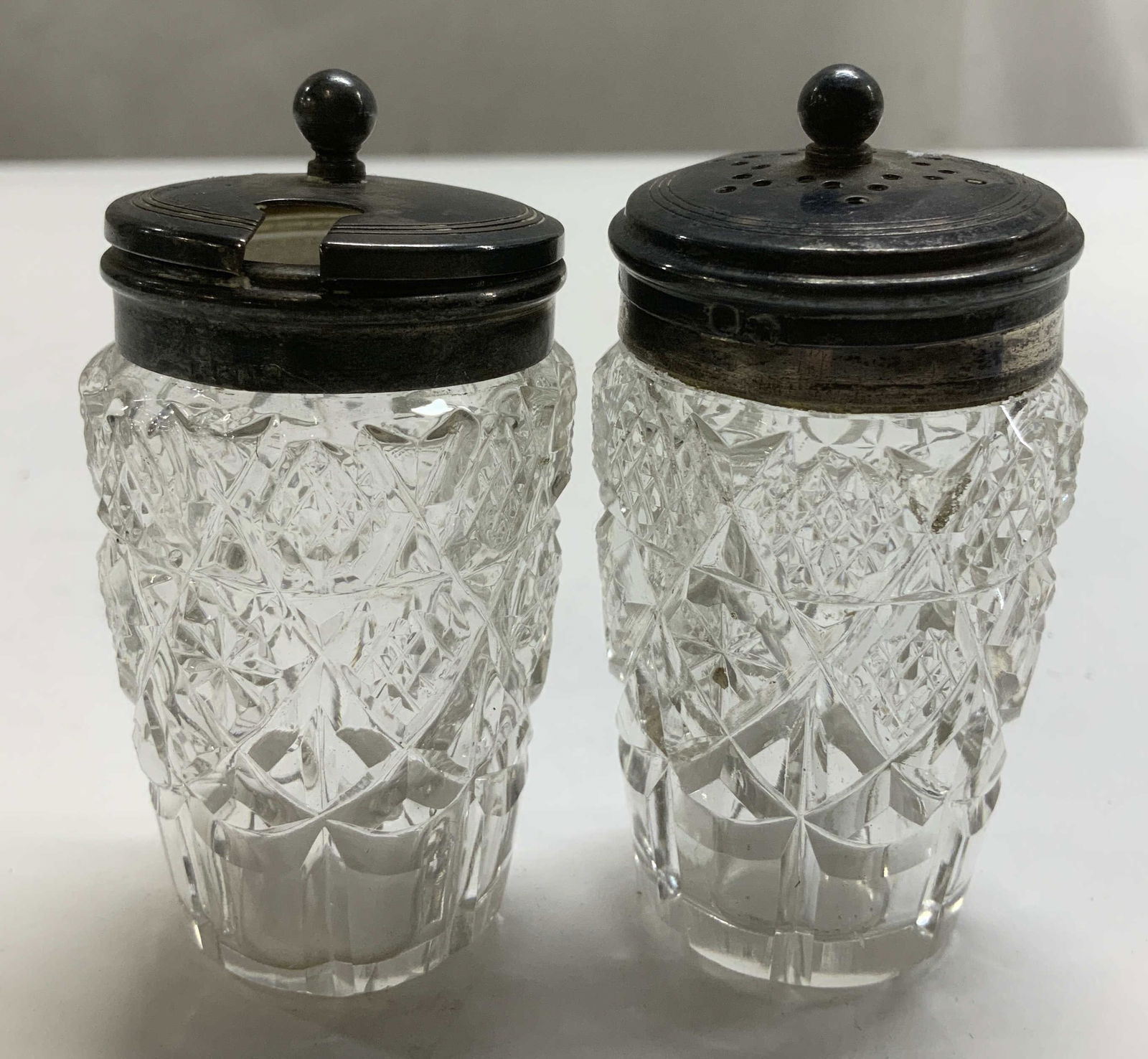 Pair Antique EPNS Shaker & Condiment Jar: Appears to be possible antique. Lot includes, 1 shaker & 1 condiment jar with hinged led featuring a spoon slot. Both pieces have a geometric cut glass pattern. Signed & marked. Reads, EPNS.