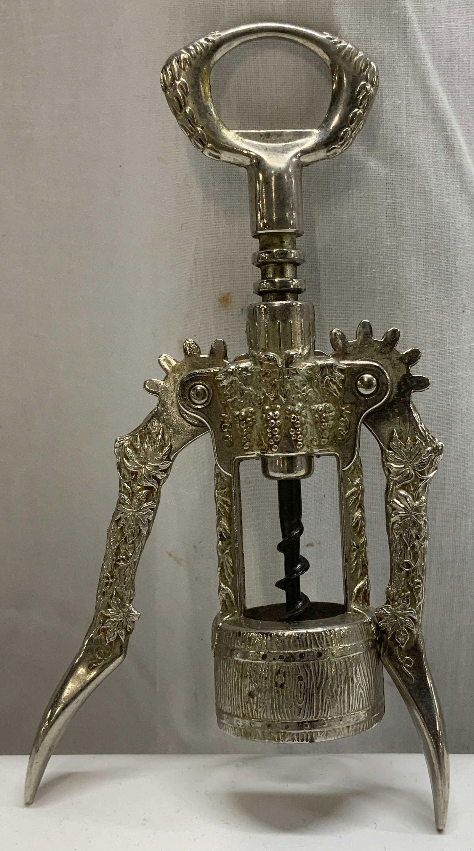 Vtg Silver Plated Winged Corkscrew: Vintage silver plated winged corkscrew features an ornate grape vine design. No visible signature or markings. Surface wear consistent to age, use & exposure. Measurements: length 7.3inx width 3.8in.