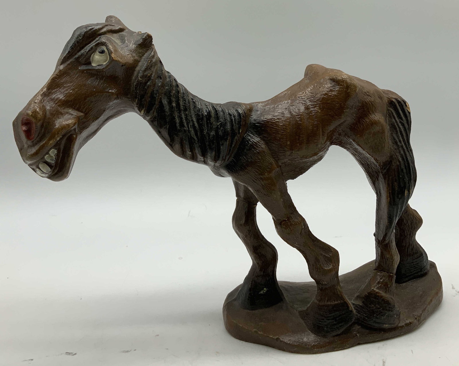 Vtg Hungry Horse Wooden Figurine: Vintage wooden figurine depicting a hungry horse with a skeletal appearance. Hand painted details on face. Brown toned. No visible signature or markings on underside. Surface wear consistent to age, u