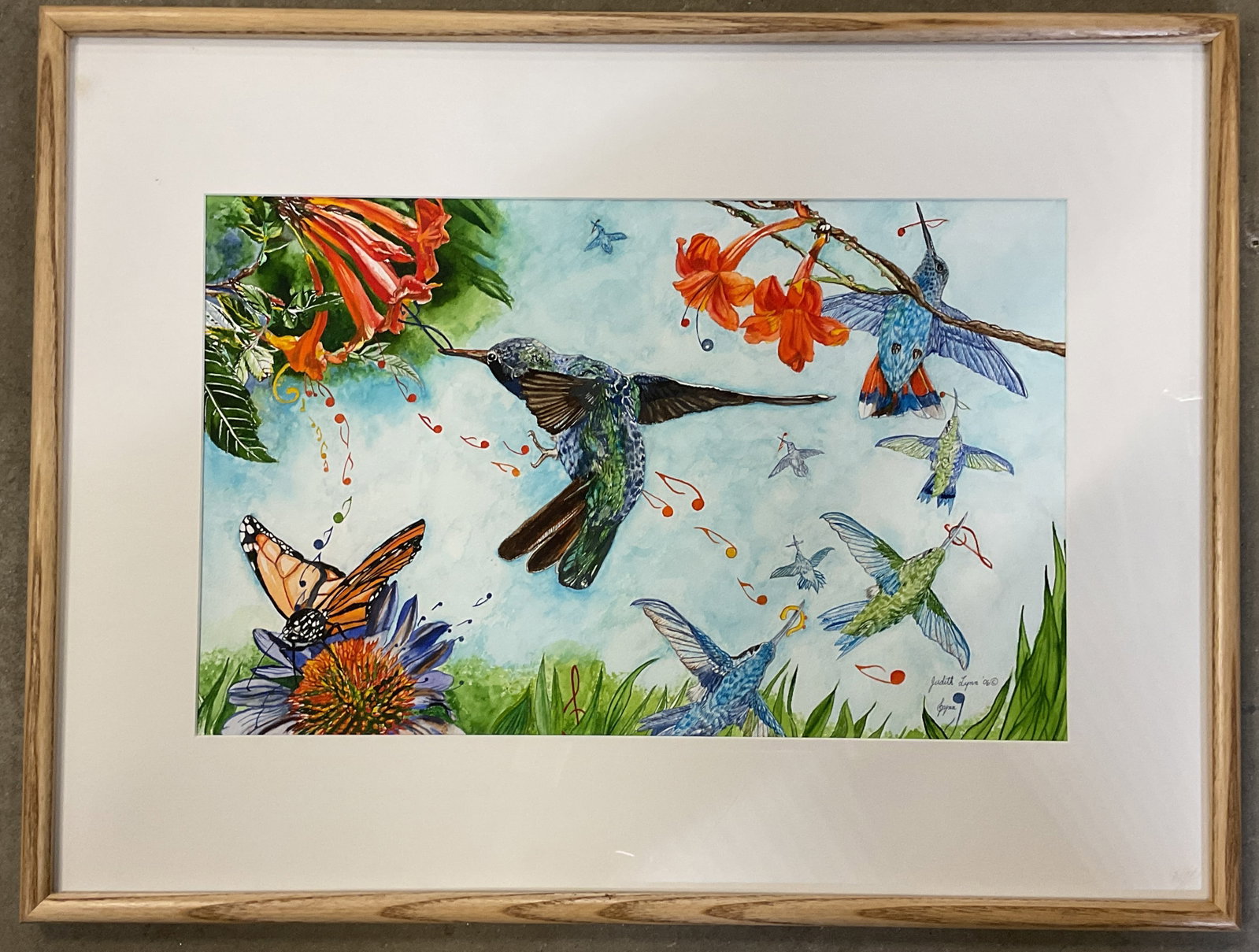 Signed Judith Lynn Hummingbird Watercolor 2006 25i: Framed and matted watercolor painting. Signed lower right, Judith Lynn, 2006. Hummingbird, flowers and music. Wood frame. Not examined out of frame. Frame measures approx. 19 x 25 inches. Some wear co