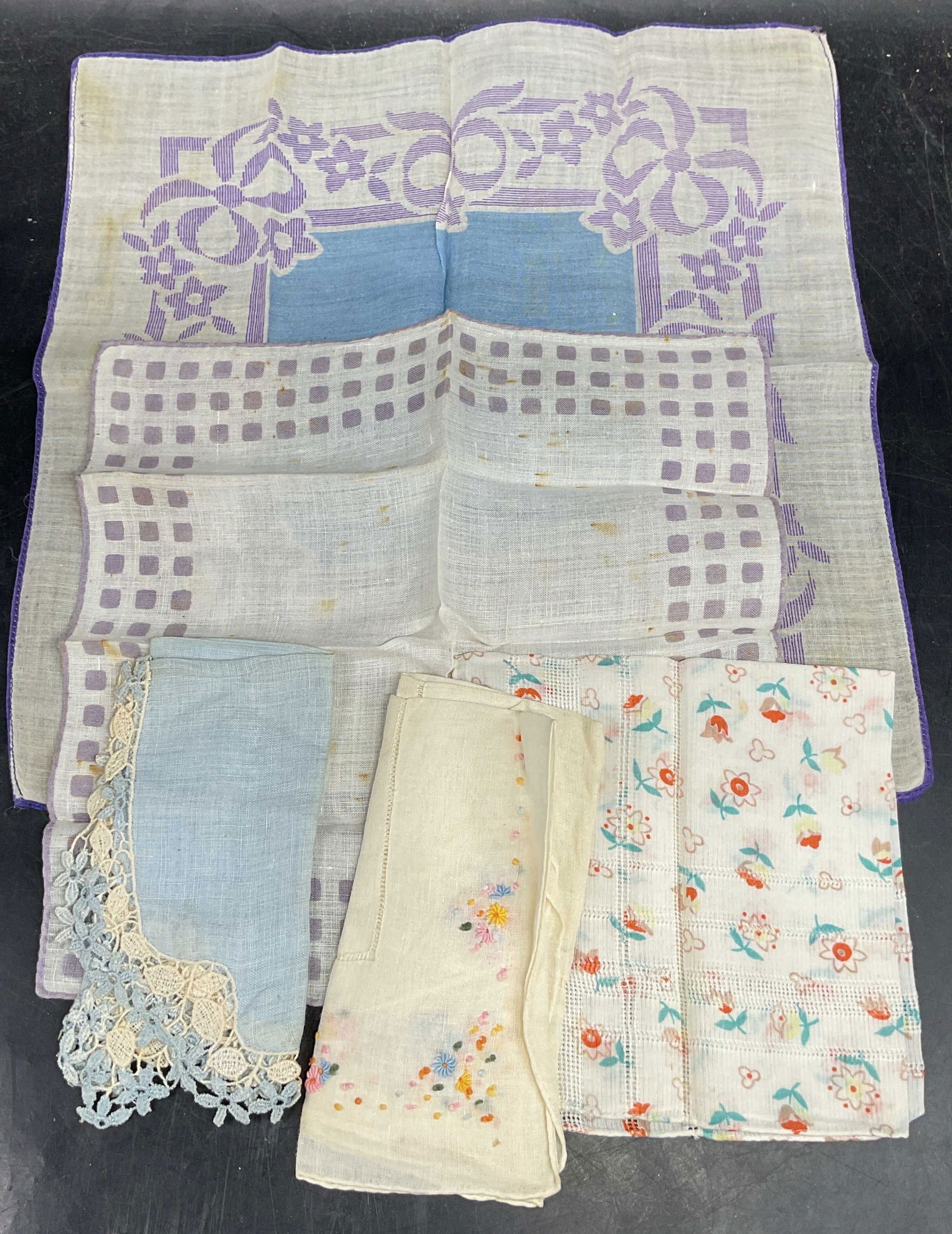 Lot 5 Vtg Purple Blue Cotton Handkerchiefs: Lot of 5 vintage cotton handkerchiefs. Purple, blue, and multicolor. Blue with lace edge, floral print, floral embroidery, and checkered. Largest measures approx. 11 x 11 inches. Some blemishes and sm