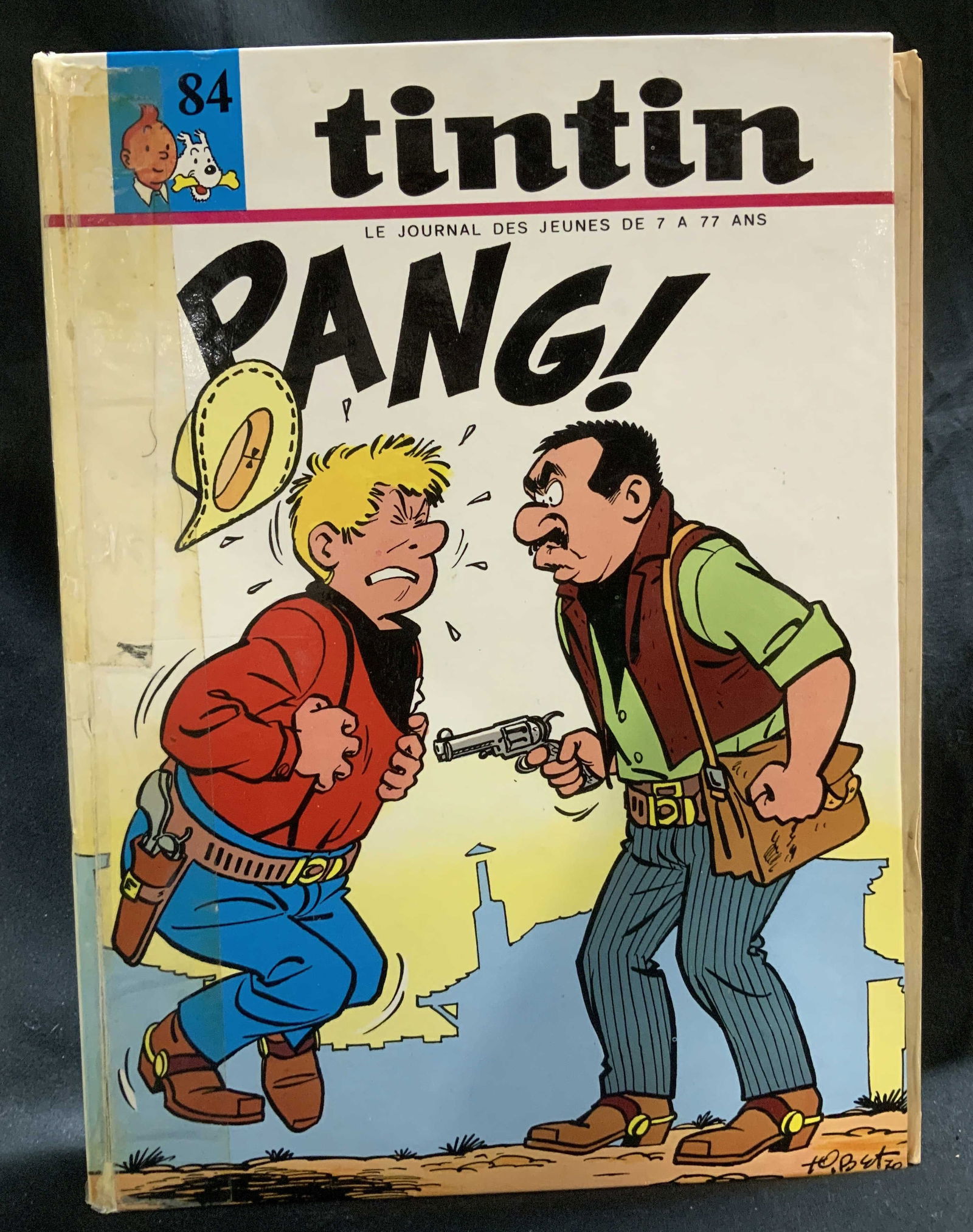 Vtg Le Journal Tintin Issue #84 Comic Book: Le Journal Des Jeunes De 7 A 77 ANS. Tintin Pang! Issue #84. Hardcover. Features various colorful comic stories. Front cover features an illustration of a western style shootout. No visible