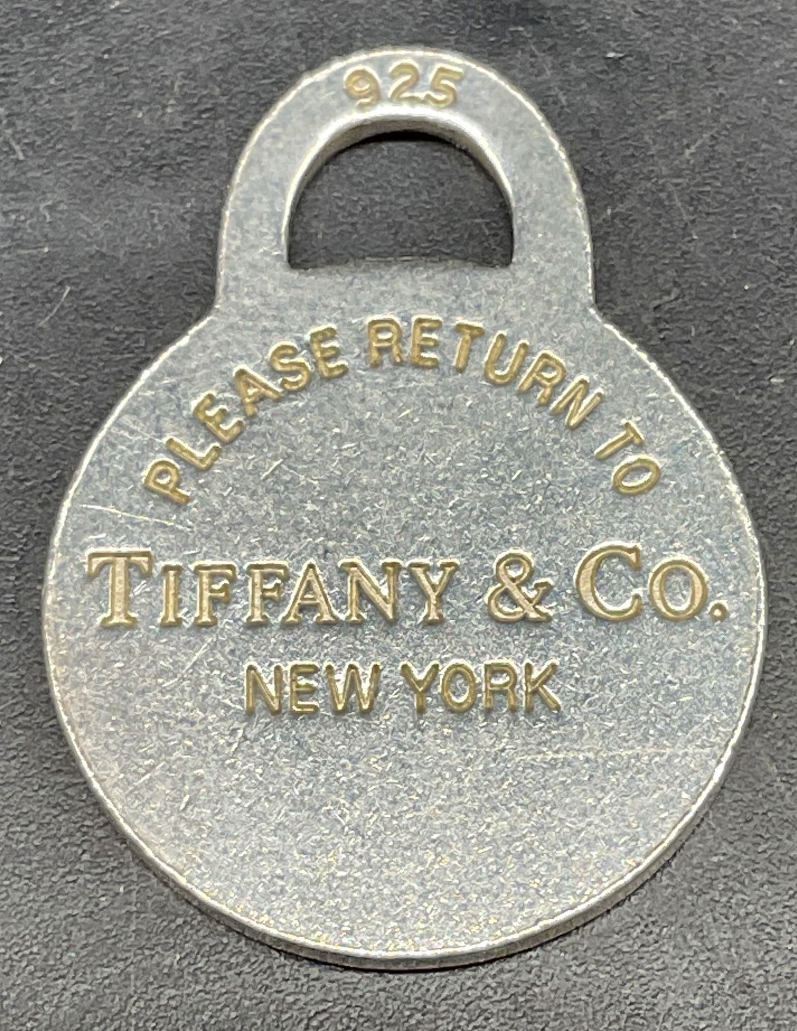Tiffany & Co Sterling Silver Round Pendant: Signed Tiffany & Co Sterling silver classic round pendant. Measures approx. 1 1/8 x .75 inches. Marked sterling. Total weight 6.2 grams. Some scratching. Jewelry, estate jewelry, fine jewelry, cocktai