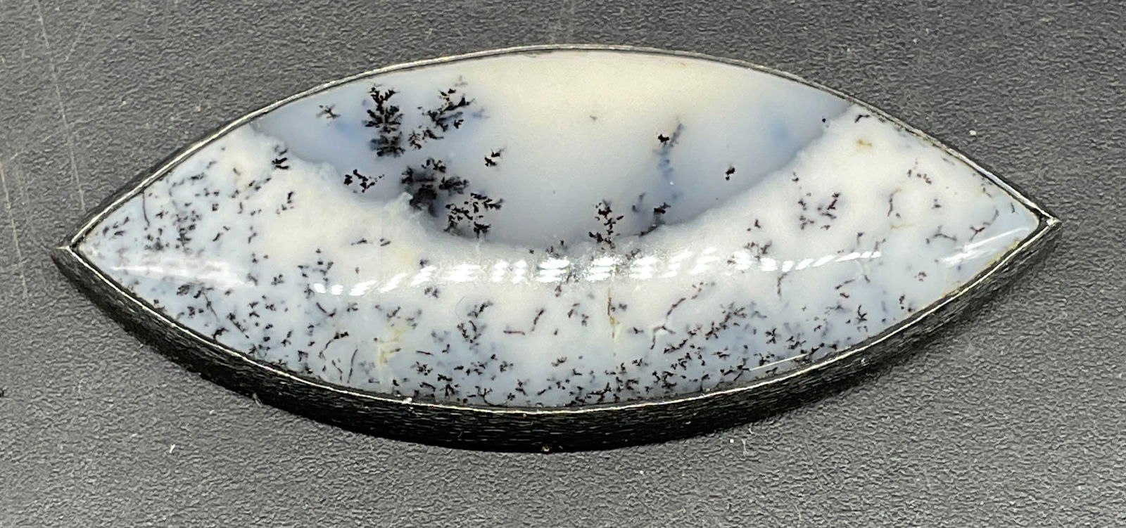 Sterling Silver Moss Agate Accessory: White and grey moss agate cabochon with sterling silver setting. Measures approx. 1 5/8 x 5/8 inches. Tested for sterling. Total weight 6.7 grams. Some scratching. Jewelry, estate jewelry, fine jewelr