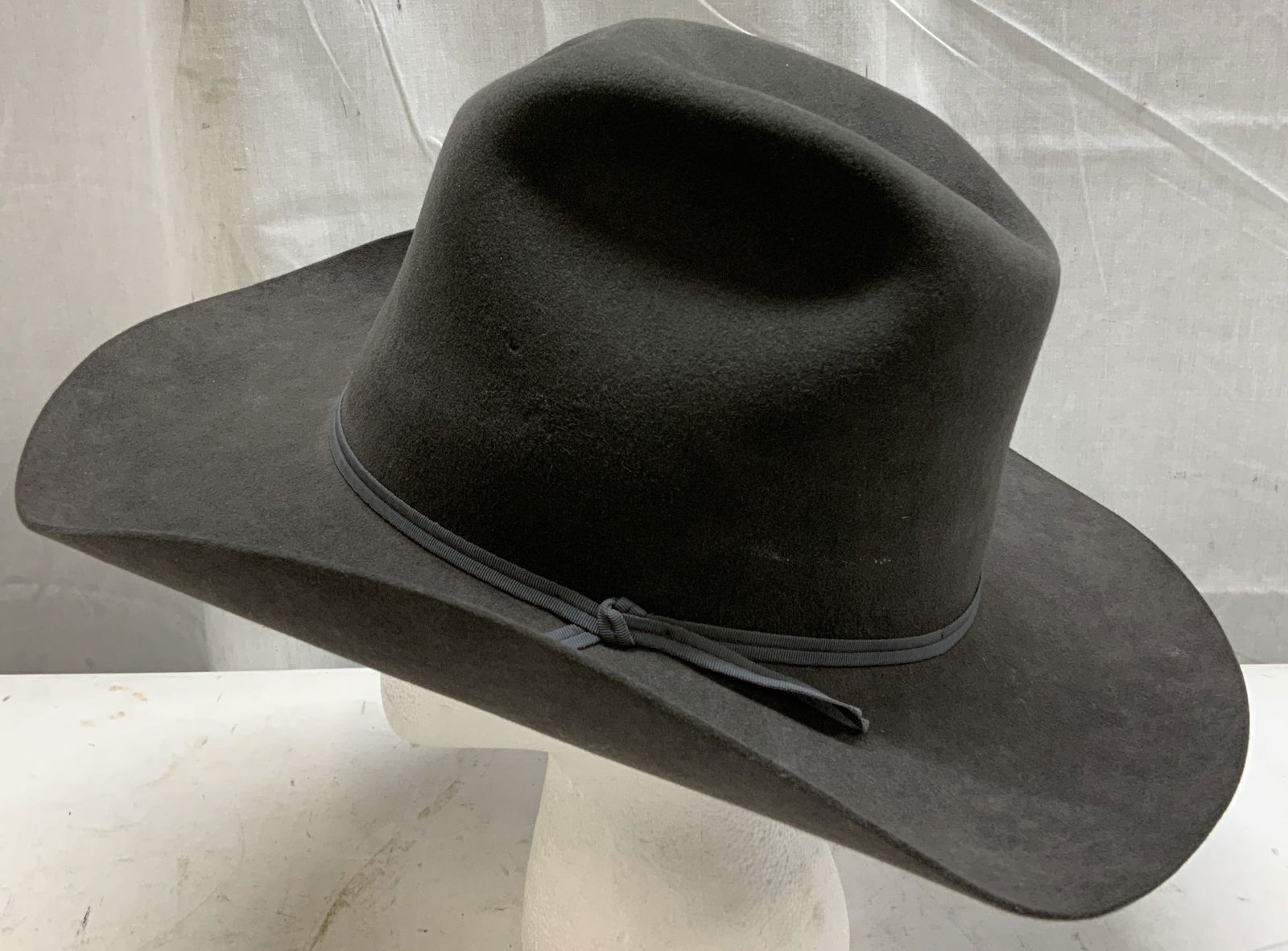 Jackson Hole Hat. Grey Felt Cowboy Hat USA: Jackson Hole Hat. Grey felt cowboy hat features a fabric hatband. Signed & marked. Reads, JACKSON HOLE HAT CO Jackson Hole Wyo (Wyoming). Surface wear consistent to age, use & exposure. Measurements: