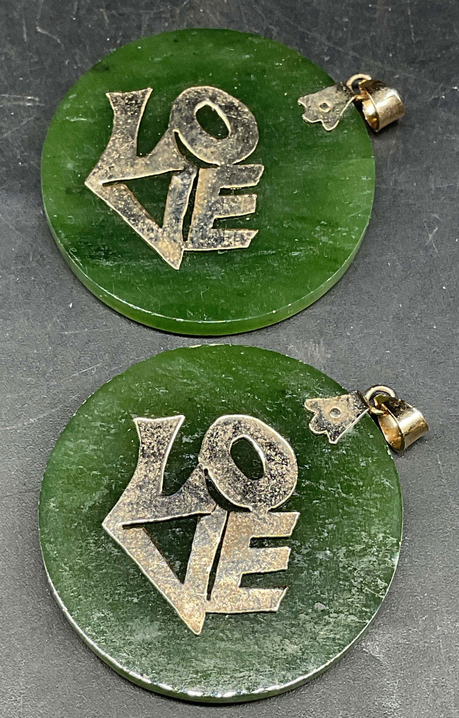 Pair Gold Tn Nephrite Jade Love Pendants: Pair of round nephrite jade pendant with Love motif and gold tone accents. Measures approx. 1.5 inches wide. Some scratching. Jewelry, estate jewelry, costume jewelry, cocktail jewelry, fashion