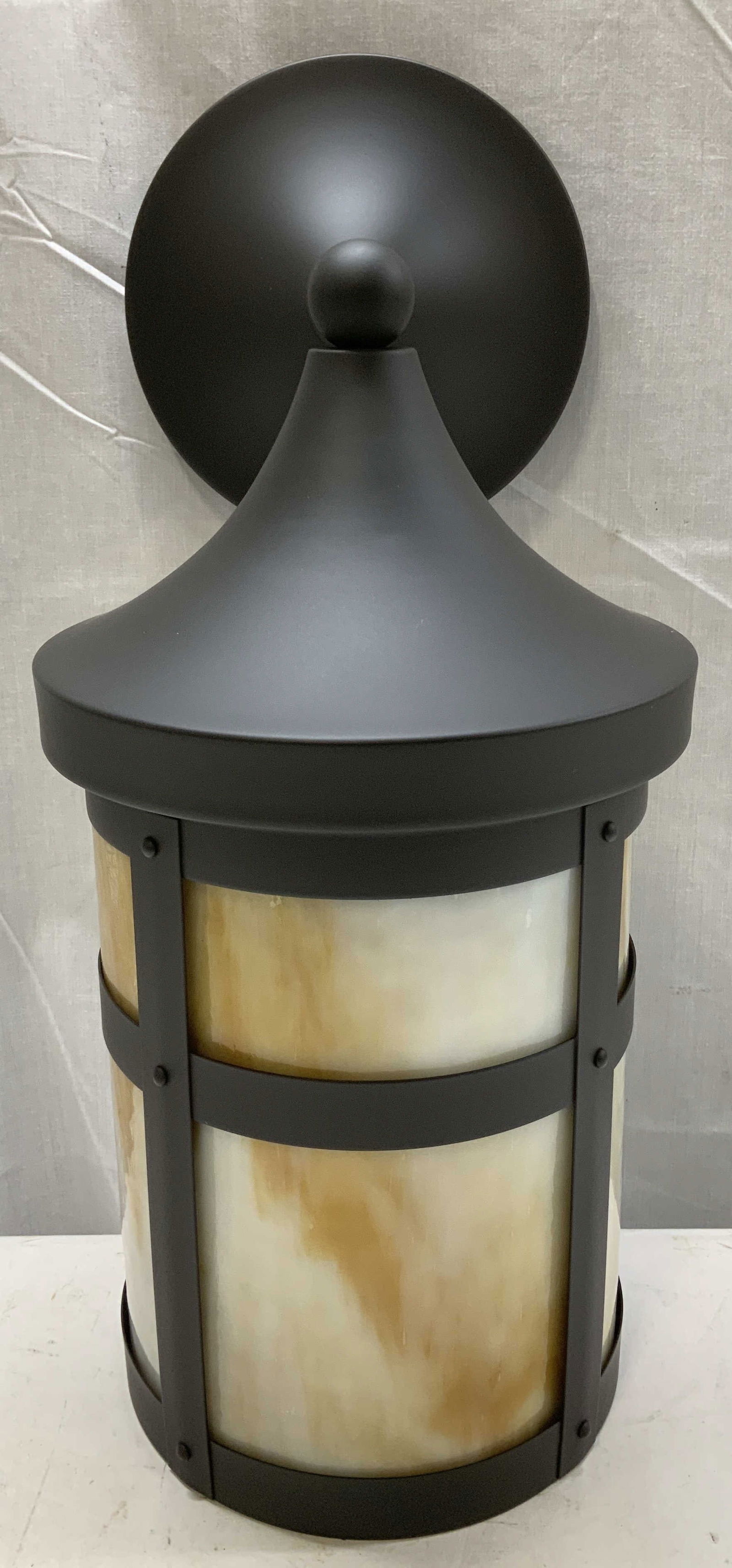 Rejuvenation Columbia Rubbed Bronze Wall Scone: Wall mounted light scone has a cylindrical form. Scone is rubbed bronze & has glass shade panels. Signed & marked. Reads, REJUVENATION. Surface wear consistent to age, use & exposure. Has not