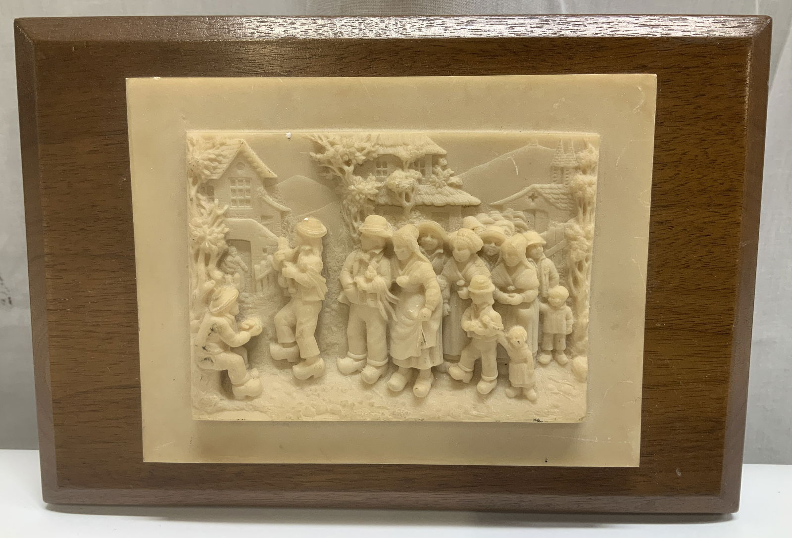 Medallic Art Company Lime & Wood Relief Plaque: Medallic Art Company bas-relief plaque featuring a detailed village scene. Limestone material & mounted on a wood frame. Signed & marked on underside. Reads, MEDALLIC ART COMPANY. Surface wear