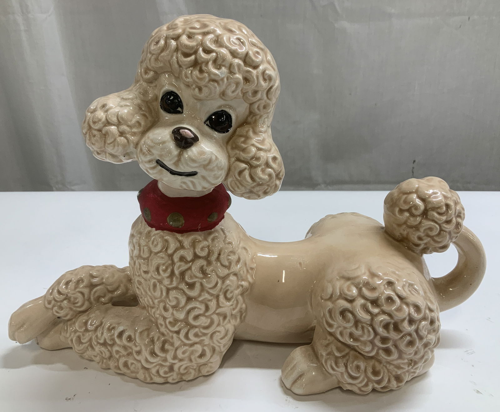 Vtg Atlantic Mold Ceramic Poodle Figurine: Vintage ceramic poodle figurine featuring a spaghetti texture & hand painted details. Shades of pink, red & brown. Signed & marked on underside. Reads, ATLANTIC MOLD. Surface wear consistent to