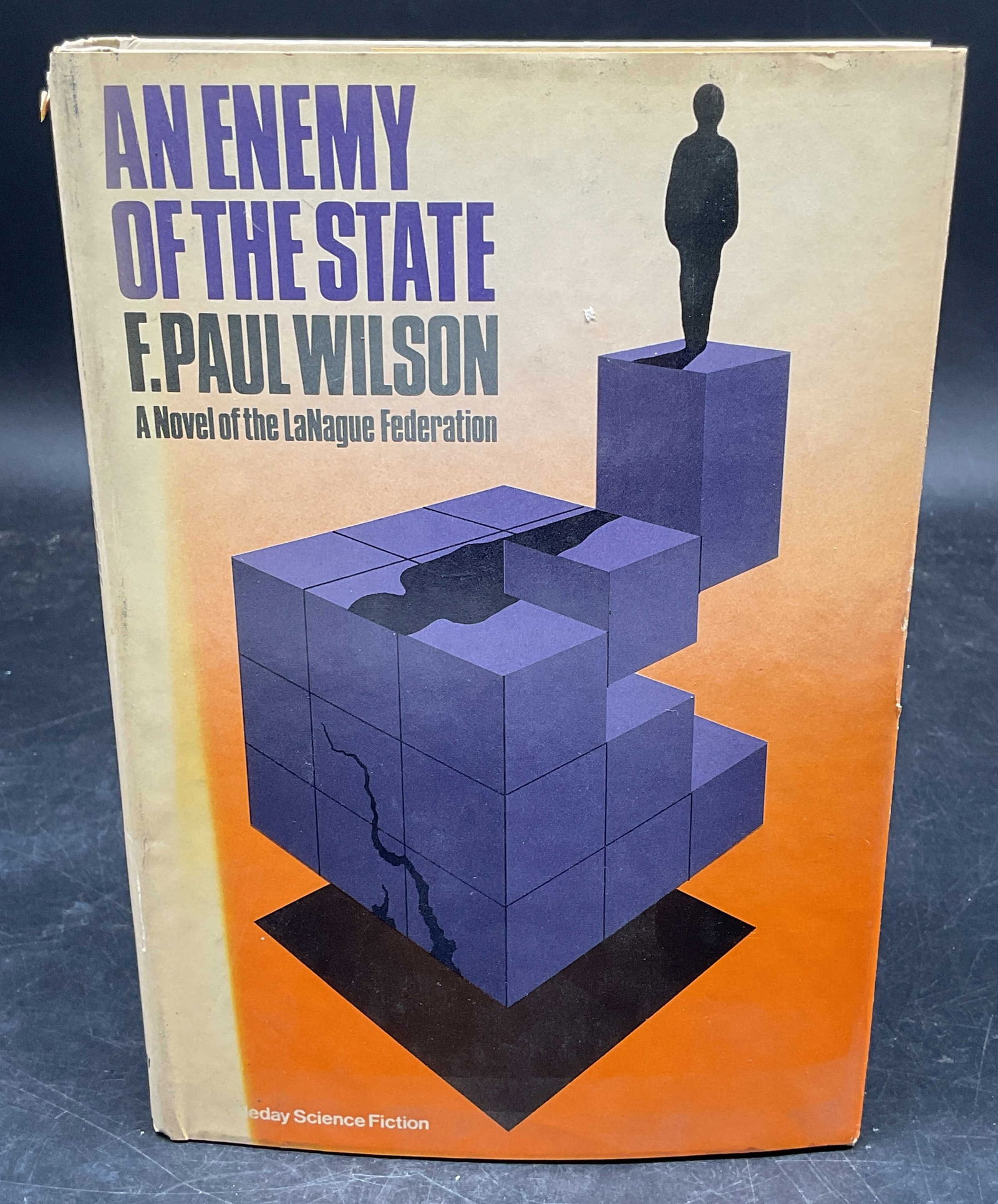 Wilson Enemy of the State 1st Ed 1980: Hardcover first edition An Enemy of the State by F Paul Wilson. Doubleday, 1980. Measures approx. 8.5 x 5.75 inches. Some wear to cover, pages, and binding consistent with exposure. Book, vintage book