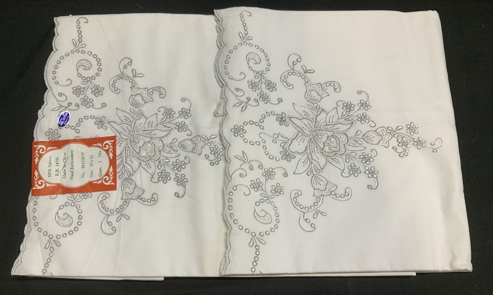 Lot 2 Vtg Hand Embroidered Cotton Pillowcases: 100% cotton. Lot includes, 2 pillowcases featuring hand embroidered floral detailing. White & grey toned. Surface wear consistent to age, use & exposure. Measurements: 22x32. Vintage hand embroidered