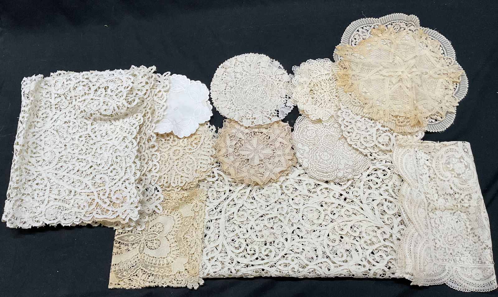 Grp Lot 62 Vtg White Embroidered Table Linens: Group lot of 62 vintage white embroidered table linens. Lace and linen. Includes 3 circular doilies, 10 placemats, and 49 coasters. Features include scalloped trim, embroidered floral and scroll motif