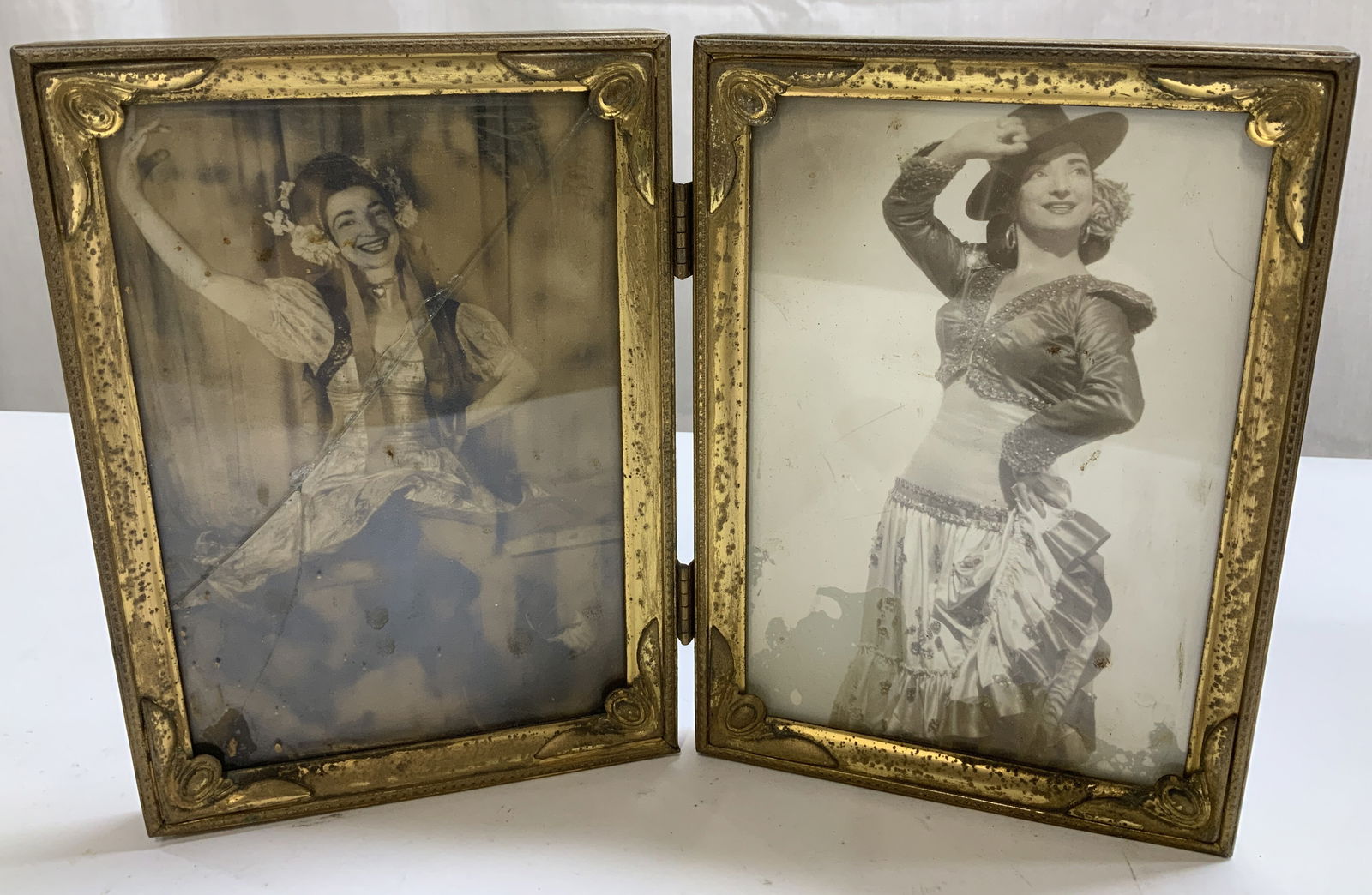 Vtg Ornate Gilt Double Folding Frame: Vintage double folding frame features a gilt finish & ornate detailing on corner. Features black & white images of woman in costumes. Metal material. Surface wear consistent to age, use & exposure. Vi