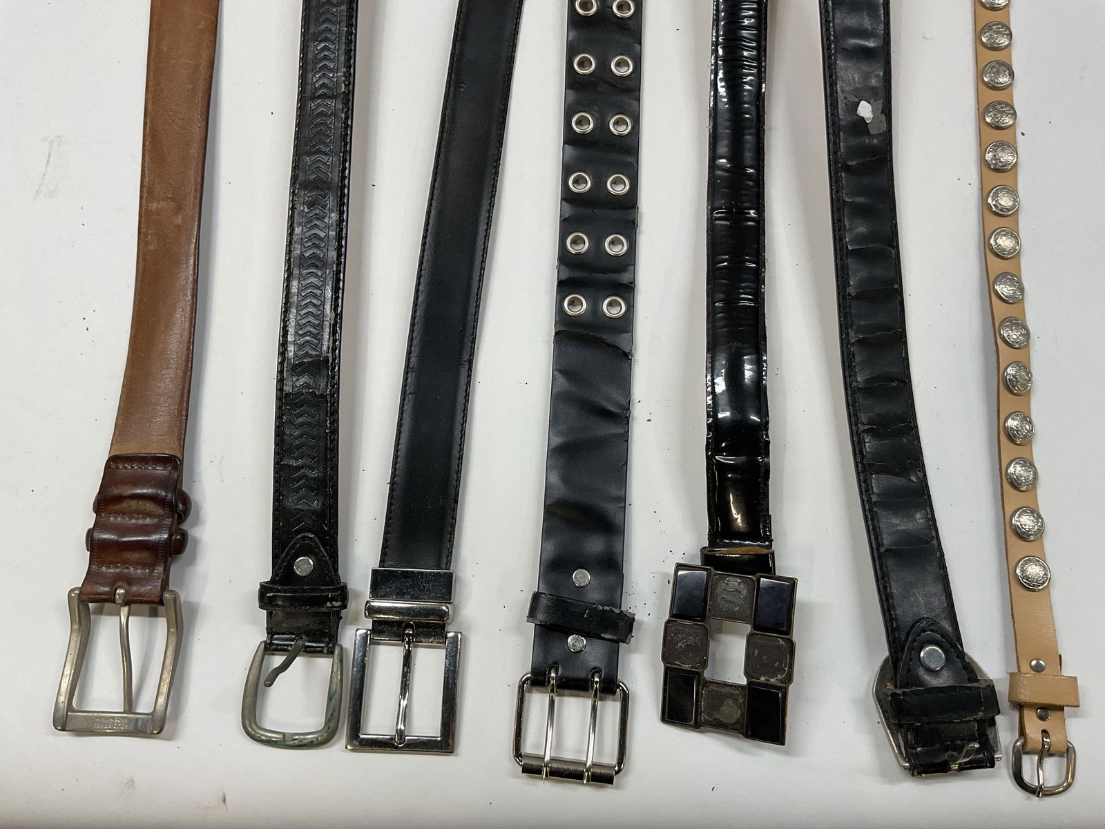 Lot 7 Tods Italy & More Leather Belts: Lot of 7 leather belts. Brands include Tods made in Italy. No other visible markings that read legible. All leather. Size, shape, color, design vary. Largest measures approx 43 inches long. Wear to al