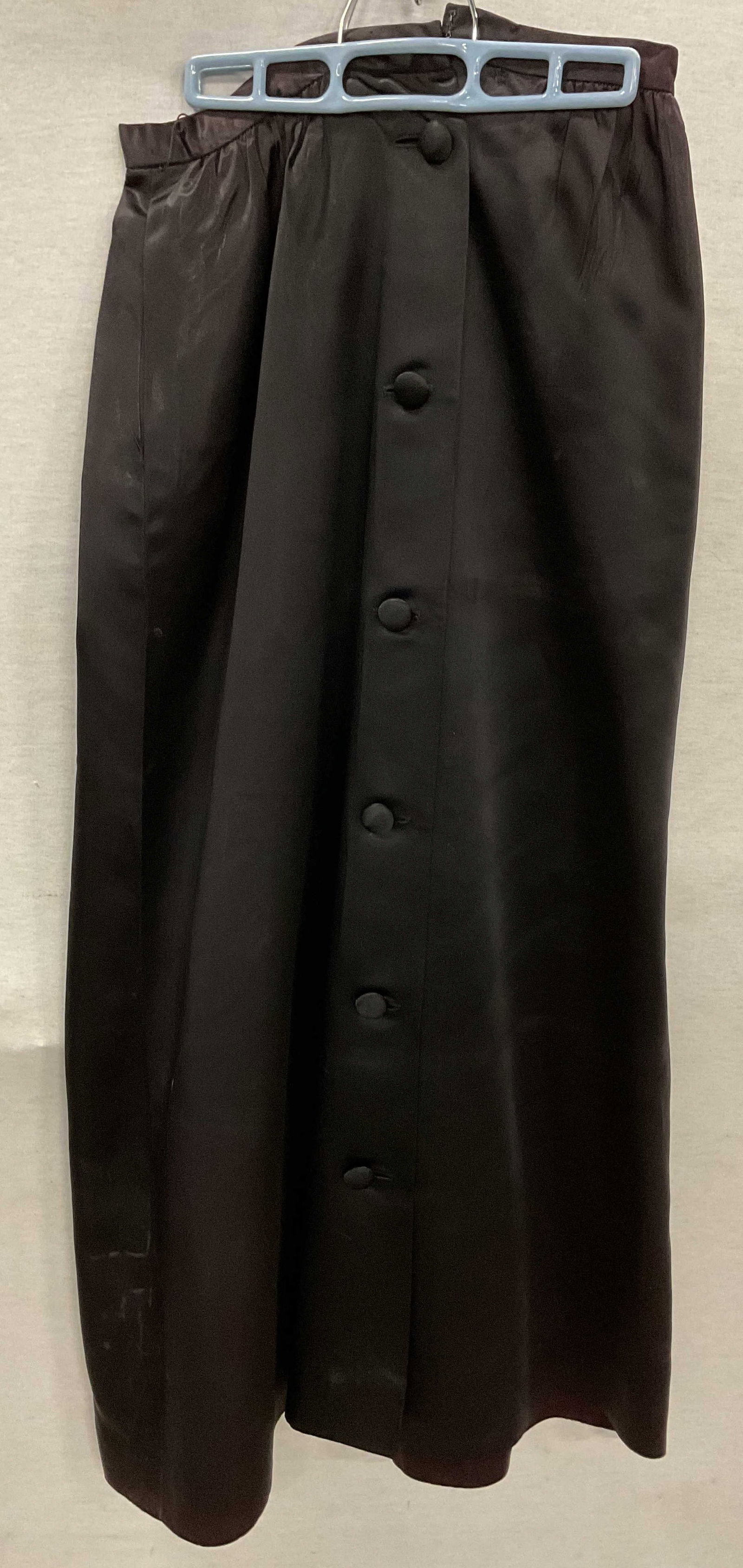 Nelly De Grab Black Buttoned Silk Pencil Skirt: Nelly De Grab black buttoned silk pencil skirt. Size 12. Feels like silk. Flared at bottom. Black button decoration along frontside. Wear at waistband. Property of opera singers estate from the renown