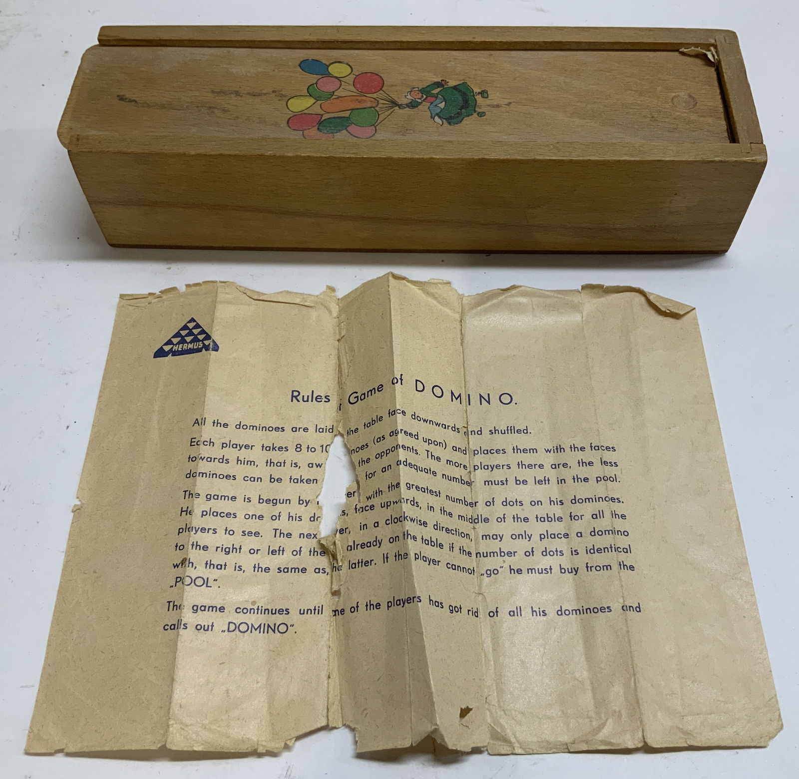 Vtg Hermus Dominos Set, Instructions & Box: Lot includes, Hermus dominos set, instruction & wooden box with lid illustrating a woman holding balloons. Lot is sold as is. Has not been inspected for complete pieces. Surface wear consistent to age