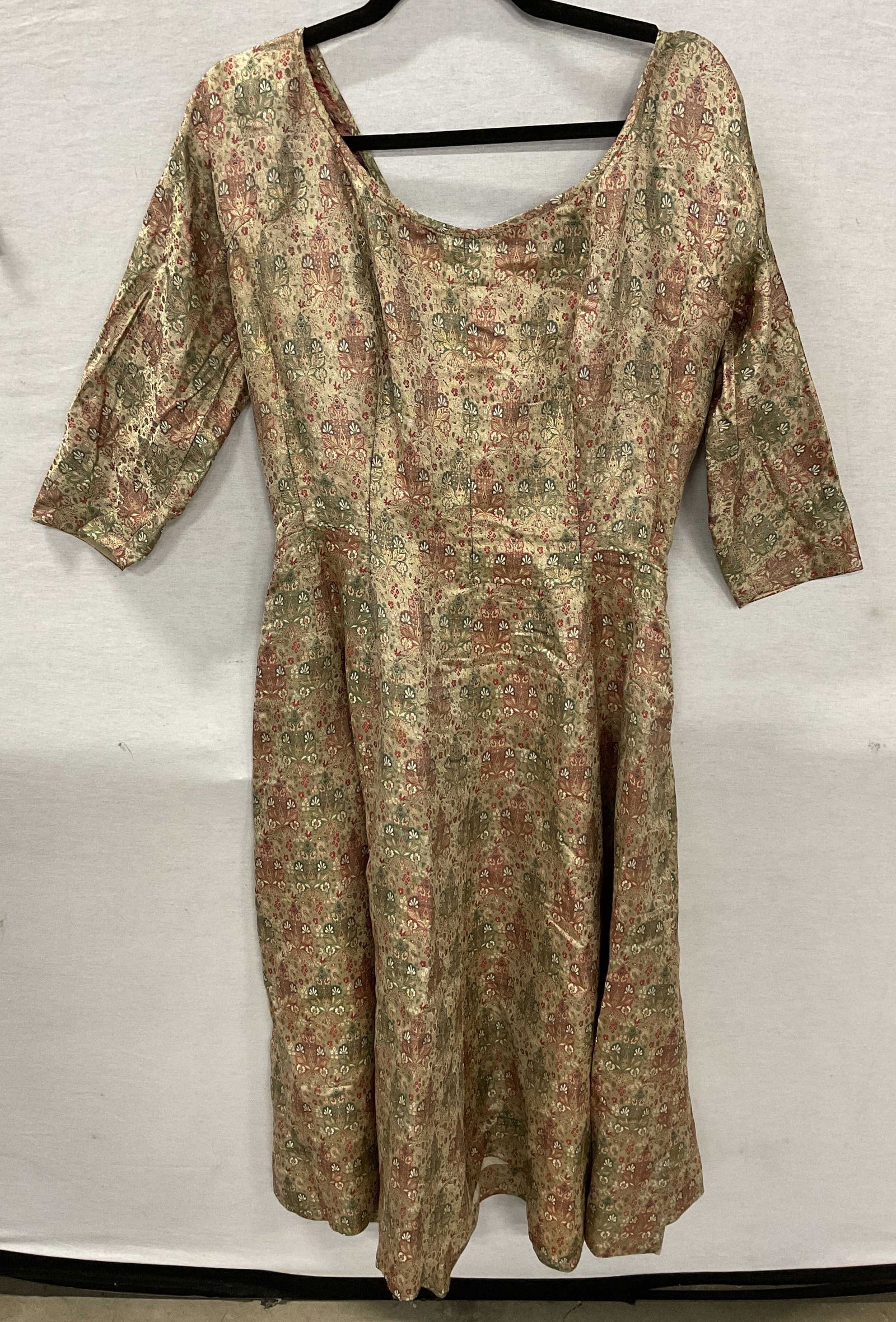 C.1920s Handmade Fabric Dress: Circa 1920s. Handmade fabric dress. Made of fabric, feels like cotton. Flares at bottom. Back zipper. Pleated design. Measures approx 16 inches across waist. Red, green, and gold toned. Wear consisten