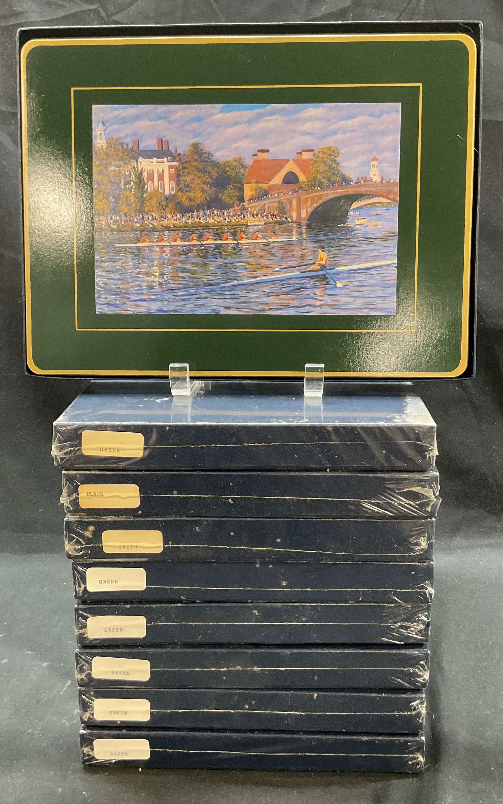 Lot 9 Ebbels Black & Green Coasters England NIP: New in packaging. Nine boxes. Unopened box has four coasters. Black and green coasters. Reads Hand Made In England Ebbels. Wooden rectangular coasters with hand painted landscape imagery. Gilt accents