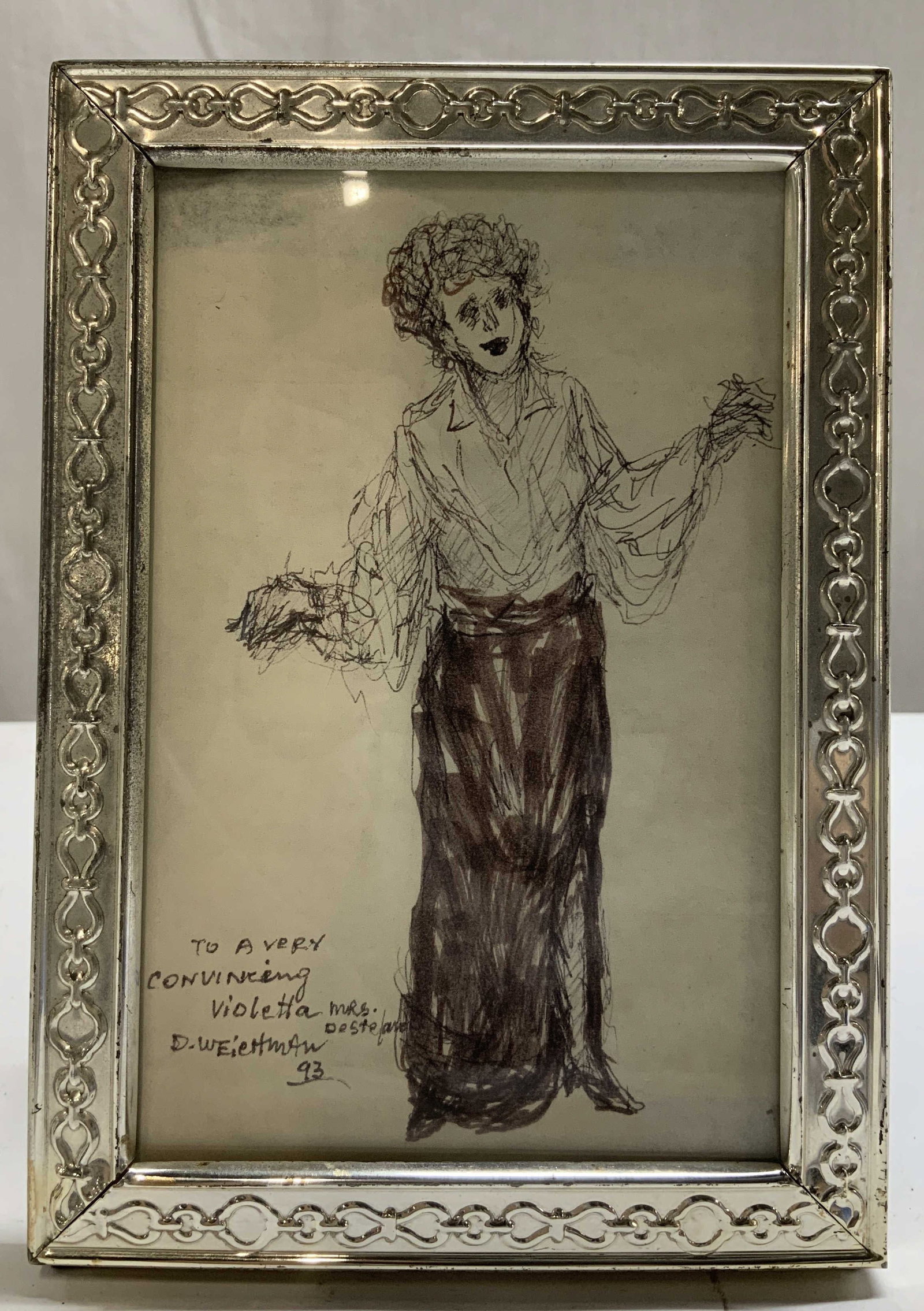 1993 Sgnd Drawing of Woman W Silver Toned Frame: Lot includes, a silver toned frame with a chain link style border. Center portrays a drawing of a woman & handwritten inscriptions. Reads, To a very convincing Violetta. D. Weichman 93. Mrs. Dest.. re